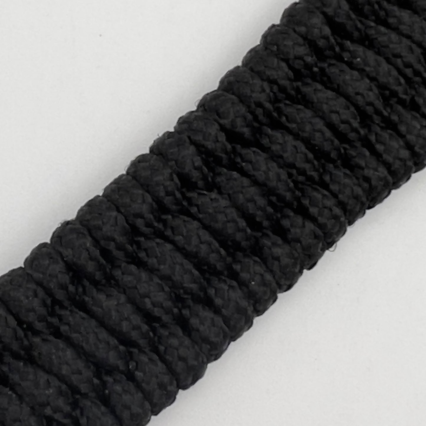 Thin, narrow, flexible and comfortable braided United States Marine Corps bracelet featuring a 24K antique gold plated USMC Eagle Globe and Anchor medallion, a black Cobra style tactical buckle and woven with black Type-1 paracord.