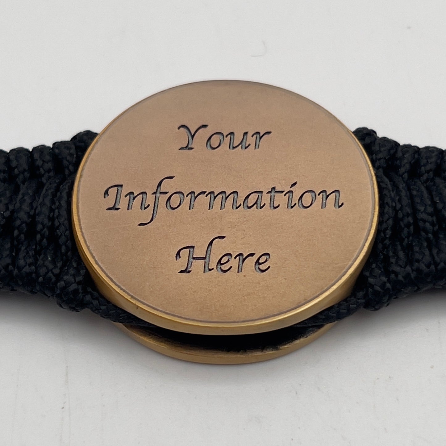 Thin, narrow, flexible and comfortable braided United States Marine Corps bracelet featuring a 24K antique gold plated USMC Eagle Globe and Anchor medallion, a black Cobra style tactical buckle and woven with black Type-1 paracord.