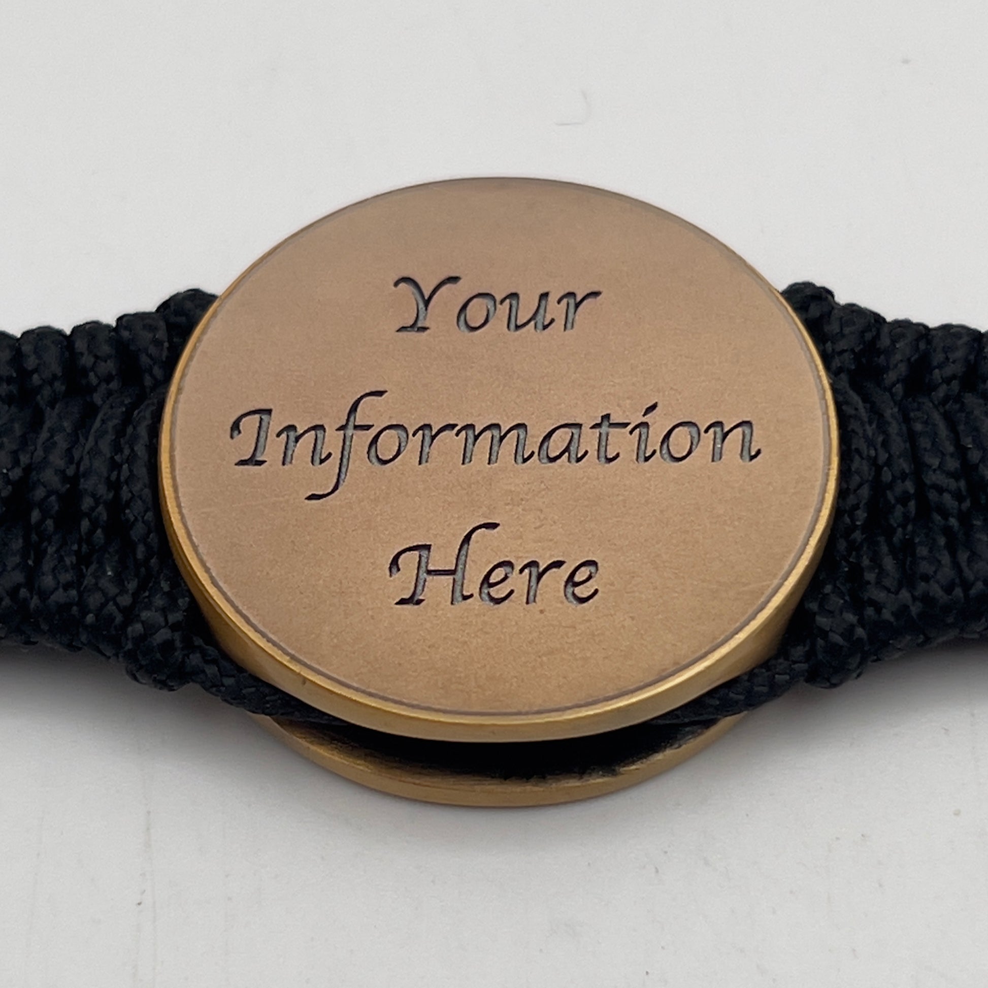 Thin, narrow, flexible and comfortable braided United States Marine Corps bracelet featuring a 24K antique gold plated USMC Eagle Globe and Anchor medallion, a black Cobra style tactical buckle and woven with black Type-1 paracord.