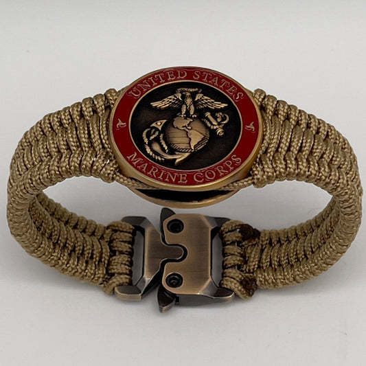 Thin, narrow, very thin and flexible and comfortable braided United States Marine Corps bracelet featuring a 24K antique gold plated USMC Eagle Globe and Anchor medallion, a gold Cobra style tactical buckle and woven with gold Type-1 paracord.