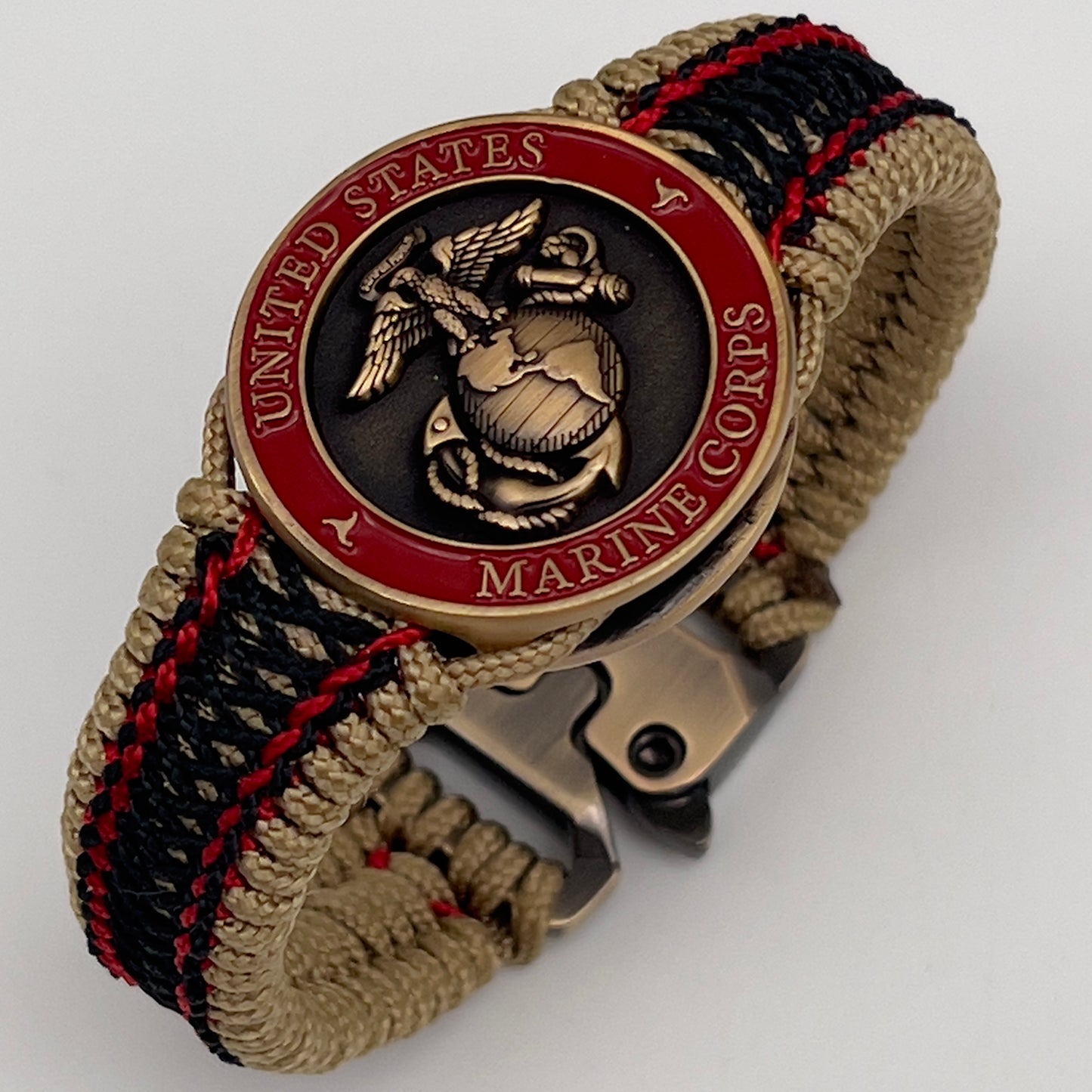 Thin, narrow, very thin and flexible and comfortable braided United States Marine Corps bracelet featuring a 24K antique gold plated USMC Eagle Globe and Anchor medallion, a gold Cobra style tactical buckle and woven with gold Type-1 paracord and Imperial Red and Black nano cord.