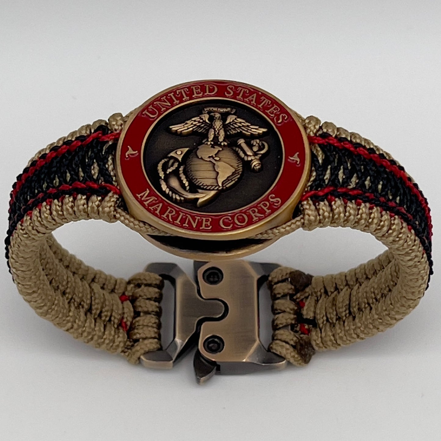 Thin, narrow, very thin and flexible and comfortable braided United States Marine Corps bracelet featuring a 24K antique gold plated USMC Eagle Globe and Anchor medallion, a gold Cobra style tactical buckle and woven with gold Type-1 paracord and Imperial Red and Black nano cord.