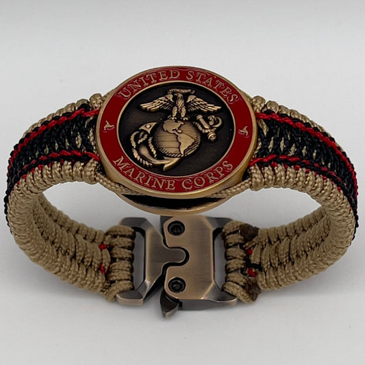 Thin, narrow, very thin and flexible and comfortable braided United States Marine Corps bracelet featuring a 24K antique gold plated USMC Eagle Globe and Anchor medallion, a gold Cobra style tactical buckle and woven with gold Type-1 paracord and Imperial Red and Black nano cord.