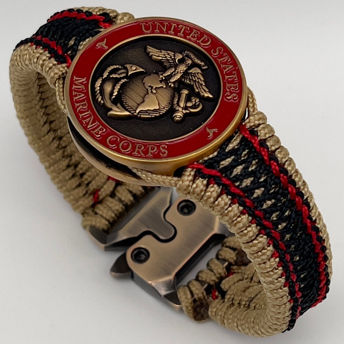 Thin, narrow, very thin and flexible and comfortable braided United States Marine Corps bracelet featuring a 24K antique gold plated USMC Eagle Globe and Anchor medallion, a gold Cobra style tactical buckle and woven with gold Type-1 paracord and Imperial Red and Black nano cord.