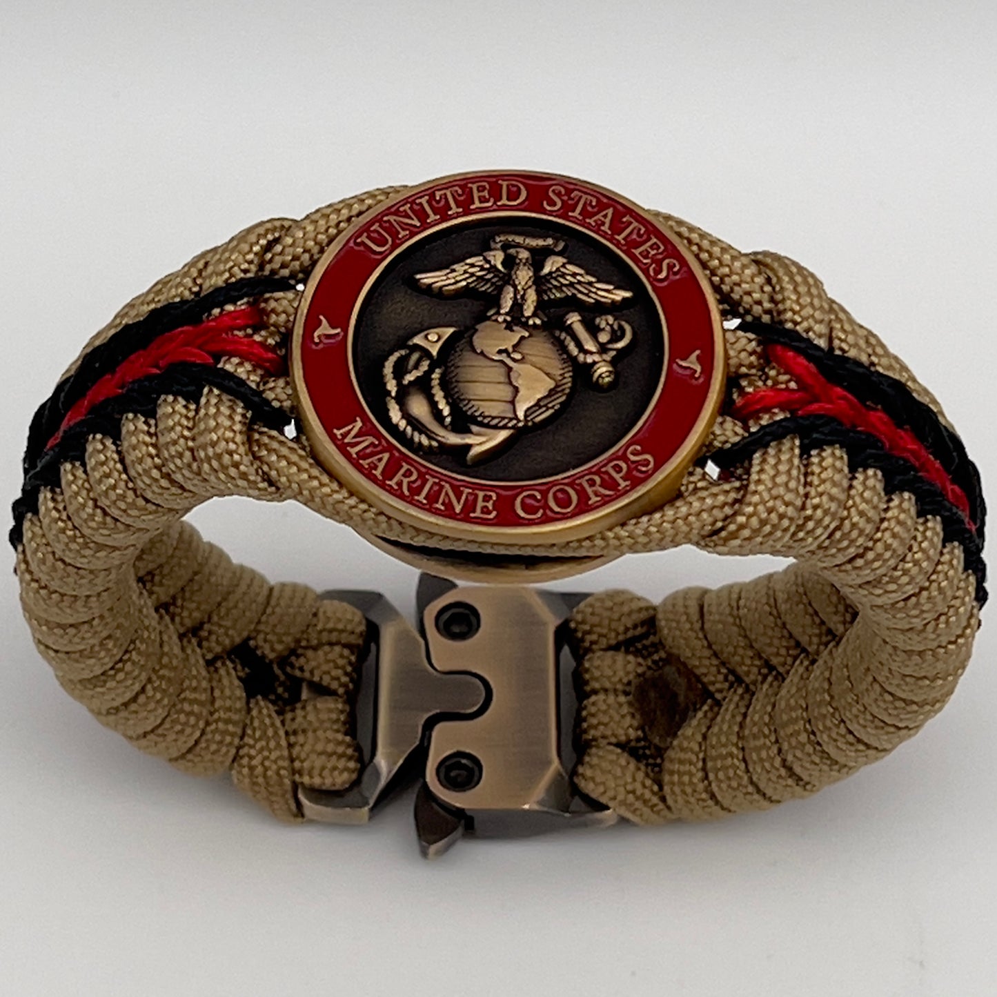 Thick, medium width, rigid and comfortable braided United States Marine Corps bracelet featuring a 24K antique gold plated USMC Eagle Globe and Anchor medallion, a gold Cobra style tactical buckle and woven with gold 550 paracord and Imperial red and black micro cord.