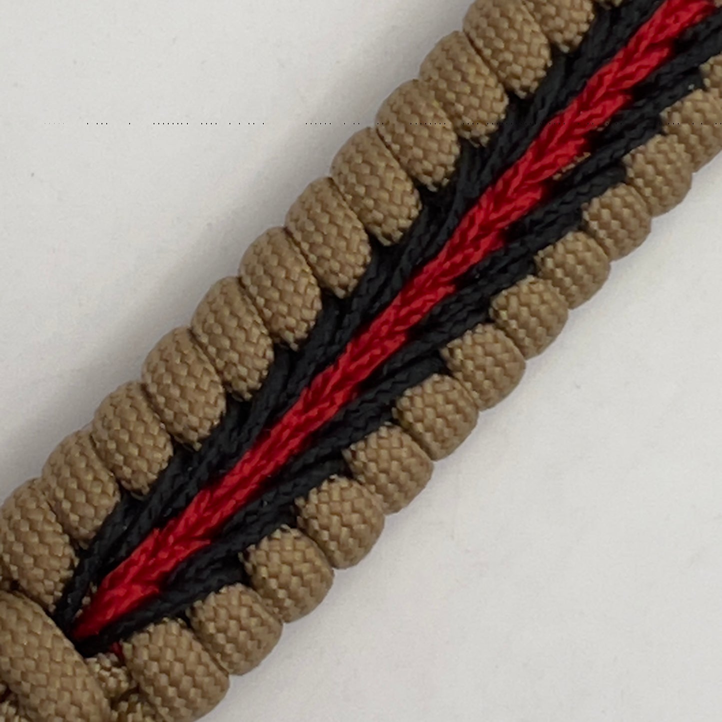 Thick, medium width, rigid and comfortable braided United States Marine Corps bracelet featuring a 24K antique gold plated USMC Eagle Globe and Anchor medallion, a gold Cobra style tactical buckle and woven with gold 550 paracord and Imperial red and black micro cord.