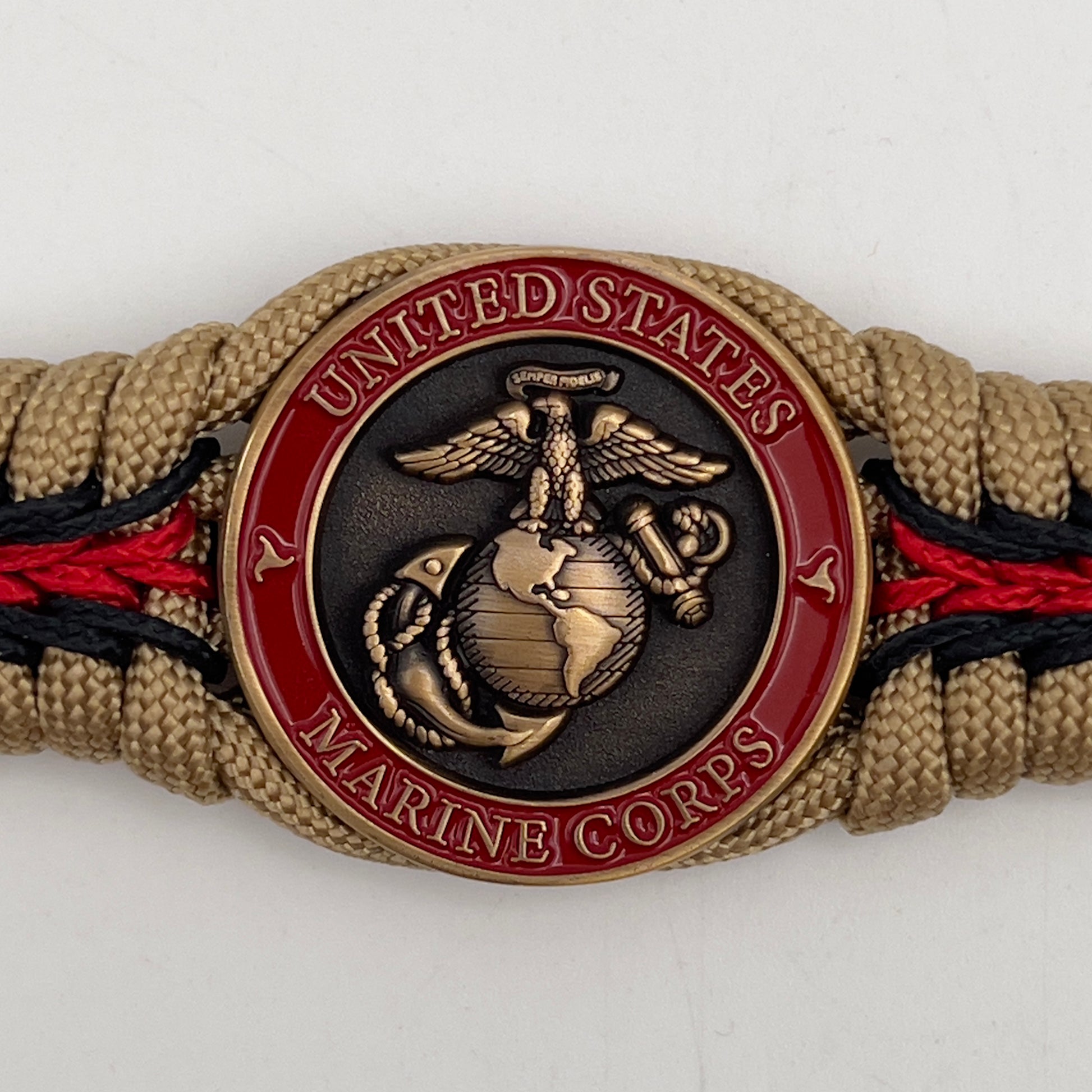 Thick, medium width, rigid and comfortable braided United States Marine Corps bracelet featuring a 24K antique gold plated USMC Eagle Globe and Anchor medallion, a gold Cobra style tactical buckle and woven with gold 550 paracord and Imperial red and black micro cord.