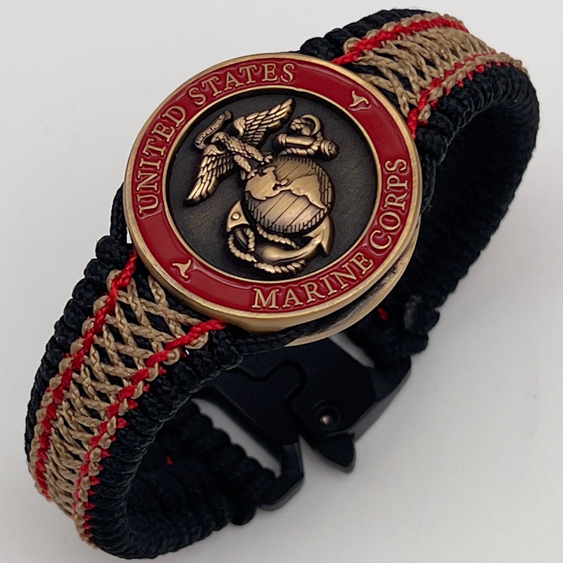 Thin, narrow, very thin and flexible and comfortable braided United States Marine Corps bracelet featuring a 24K antique gold plated USMC Eagle Globe and Anchor medallion, a black Cobra style tactical buckle and woven with black Type-1 paracord and Imperial Red and GOld nano cord.