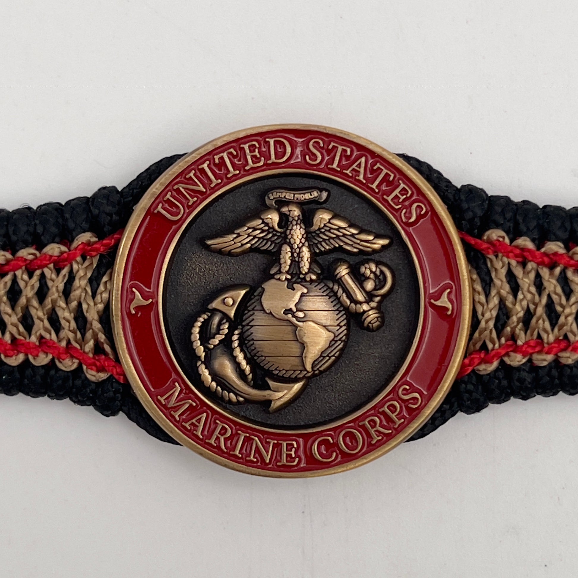 Thin, narrow, very thin and flexible and comfortable braided United States Marine Corps bracelet featuring a 24K antique gold plated USMC Eagle Globe and Anchor medallion, a black Cobra style tactical buckle and woven with black Type-1 paracord and Imperial Red and GOld nano cord.