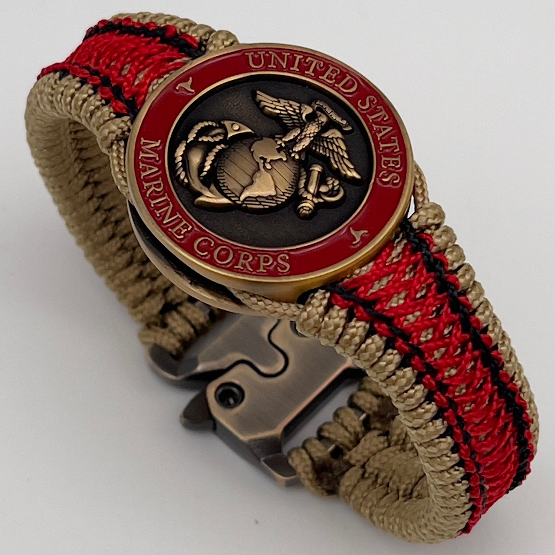 Thin, narrow, very thin and flexible and comfortable braided United States Marine Corps bracelet featuring a 24K antique gold plated USMC Eagle Globe and Anchor medallion, a gold Cobra style tactical buckle and woven with gold Type-1 paracord and Imperial Red and Black nano cord.