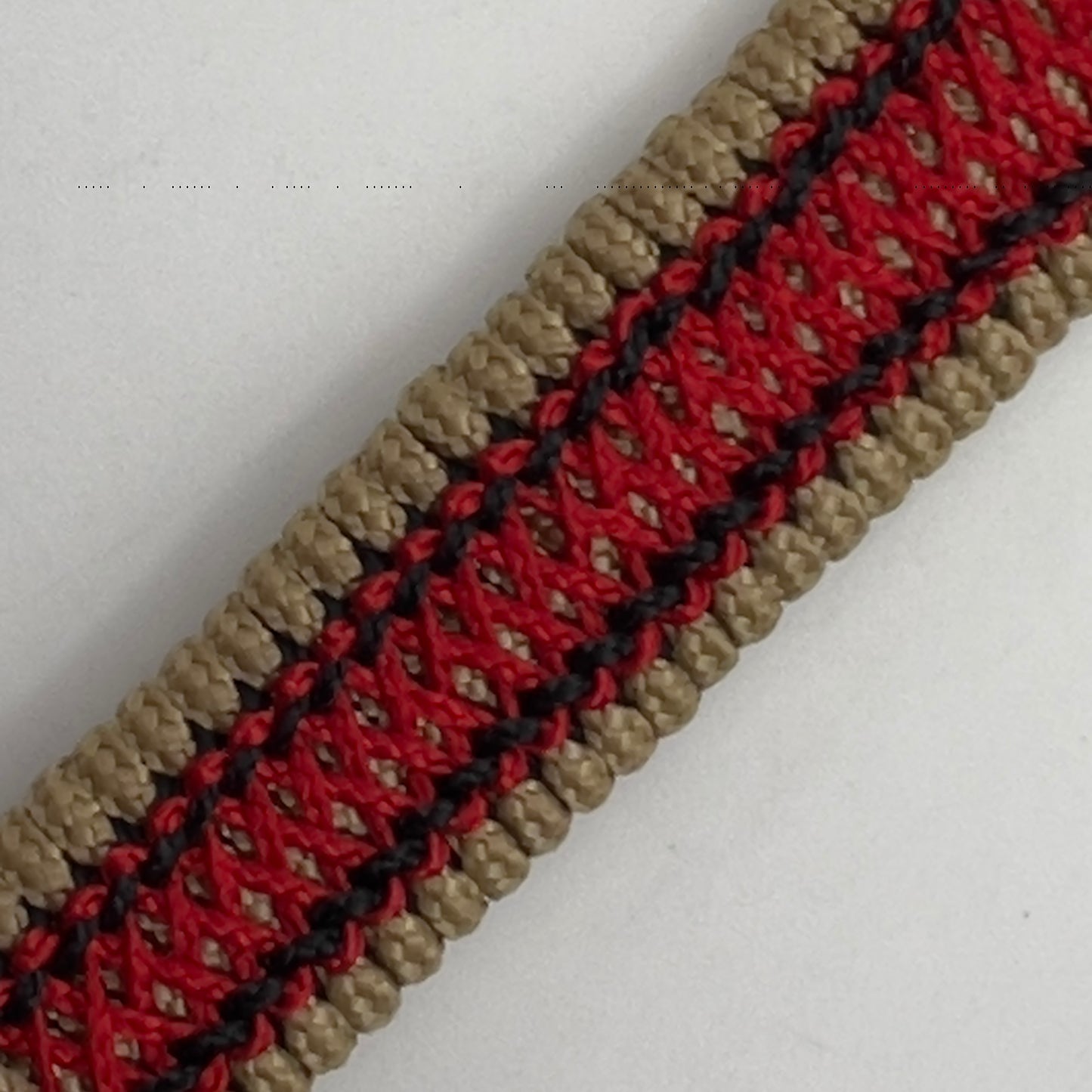 Thin, narrow, very thin and flexible and comfortable braided United States Marine Corps bracelet featuring a 24K antique gold plated USMC Eagle Globe and Anchor medallion, a gold Cobra style tactical buckle and woven with gold Type-1 paracord and Imperial Red and Black nano cord.