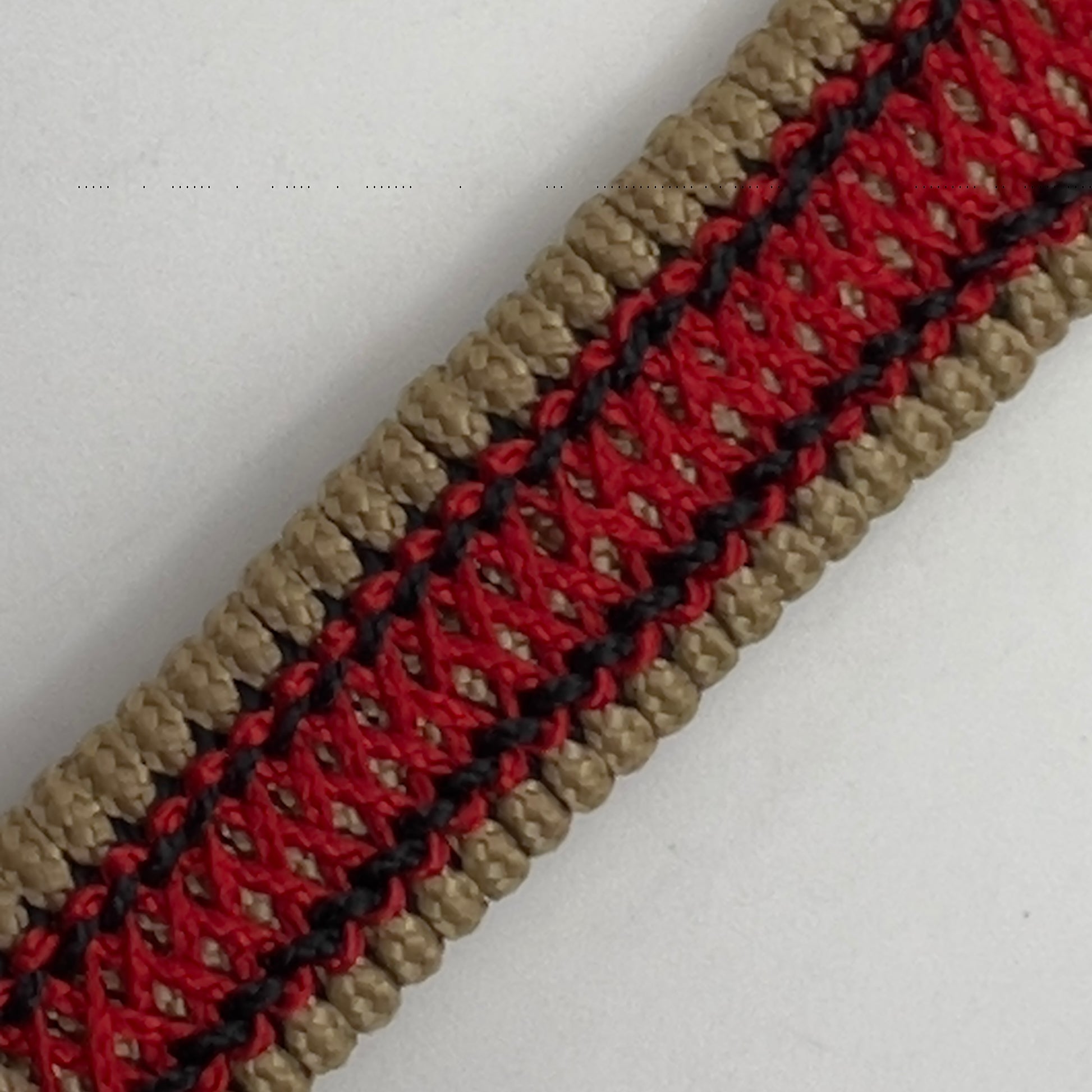 Thin, narrow, very thin and flexible and comfortable braided United States Marine Corps bracelet featuring a 24K antique gold plated USMC Eagle Globe and Anchor medallion, a gold Cobra style tactical buckle and woven with gold Type-1 paracord and Imperial Red and Black nano cord.