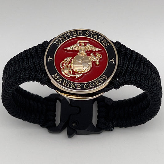 Thick, narrow, flexible and comfortable braided United States Marine Corps bracelet featuring a 24K gold plated USMC officer Eagle Globe and Anchor medallion, a black Cobra style tactical buckle and woven with black Type-1 paracord.