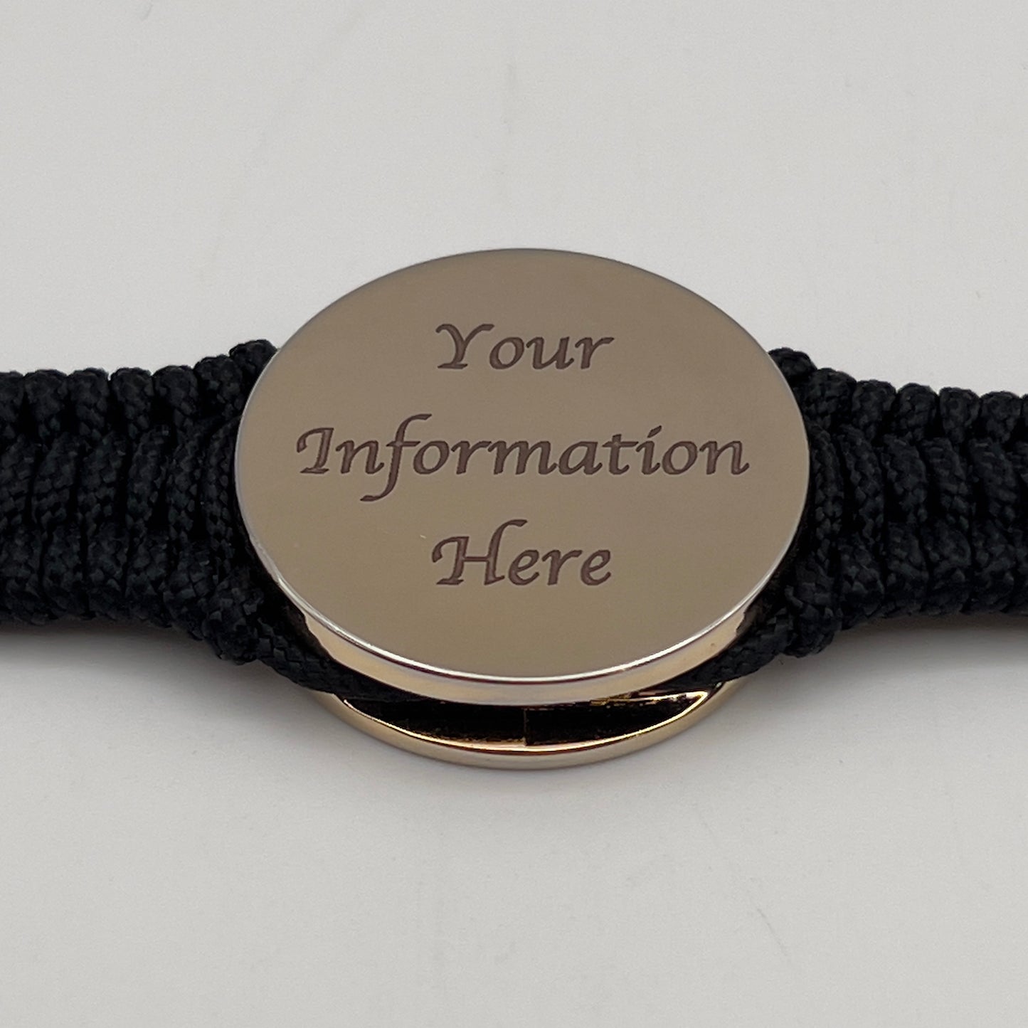 Thin, narrow, flexible and comfortable braided United States Marine Corps bracelet featuring a 24K gold and silver plated USMC Eagle Globe and Anchor medallion, a black Cobra style tactical buckle and woven with black type-1 paracord.