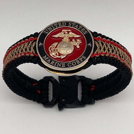 Thin, narrow, flexible and comfortable braided United States Marine Corps bracelet featuring a 24K gold plated USMC Eagle Globe and Anchor medallion, a black Cobra style tactical buckle and woven with black Type-1 paracord and Imperial Red and Gold nano cord.