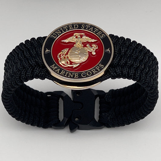 Thin, medium width, flexible and comfortable braided United States Marine Corps bracelet featuring a 24K gold plated USMC officer Eagle Globe and Anchor medallion, a black Cobra style tactical buckle and woven with black Type-1 paracord.