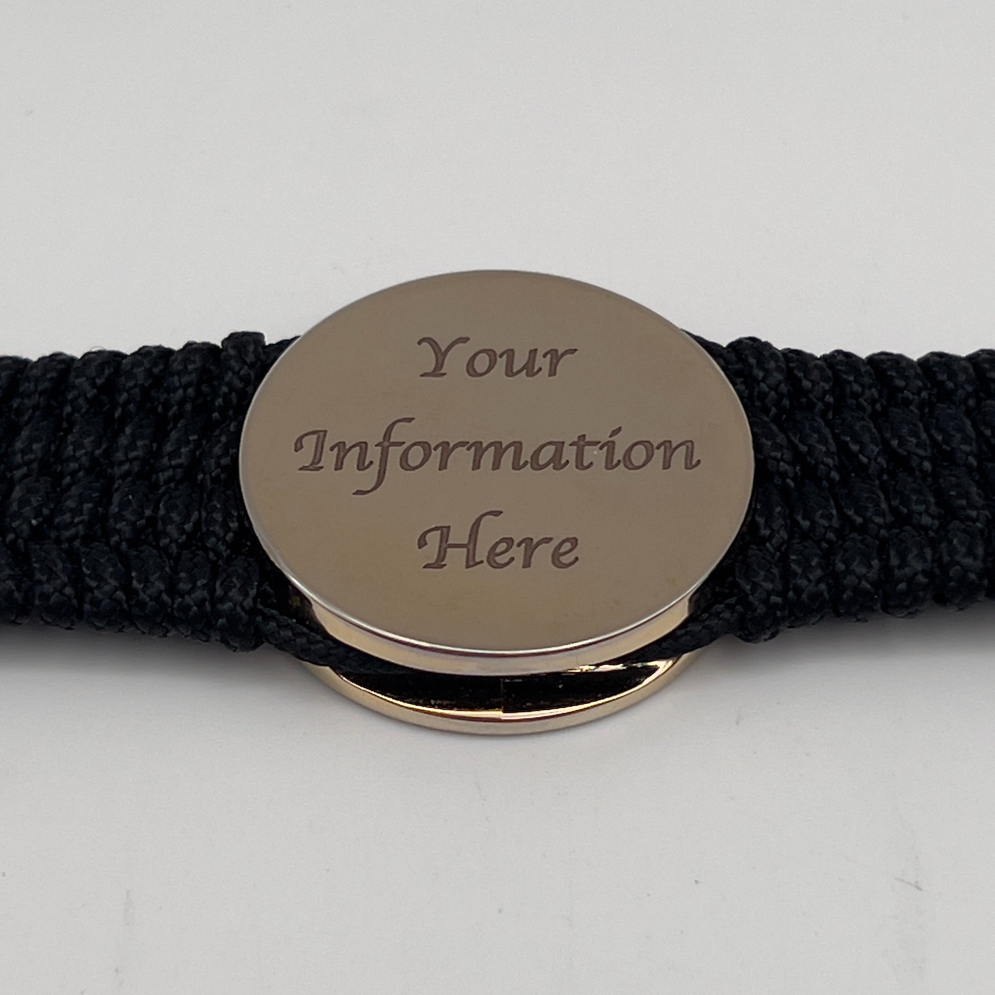 Thin, medium width, flexible and comfortable braided United States Marine Corps bracelet featuring a 24K gold plated USMC officer Eagle Globe and Anchor medallion, a black Cobra style tactical buckle and woven with black Type-1 paracord.