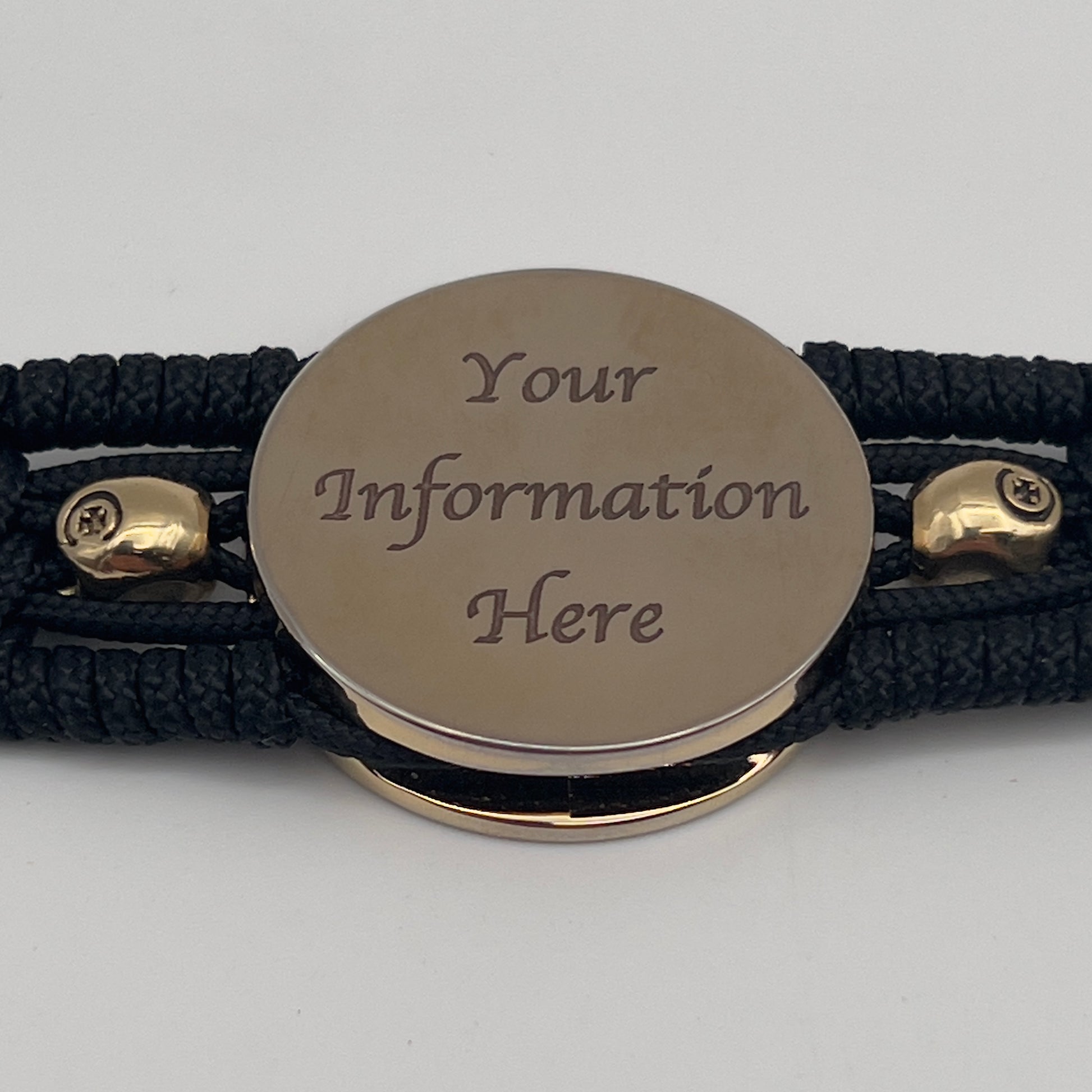 Thin, medium width, flexible and comfortable braided United States Marine Corps bracelet featuring a 24K gold plated USMC officer Eagle Globe and Anchor medallion, two gold plated skulls, a black Cobra style tactical buckle and woven with black Type-1 paracord.