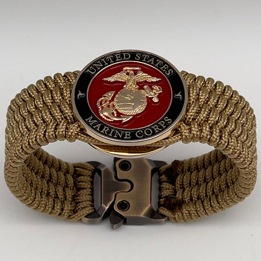 Thin, medium width, flexible and comfortable braided United States Marine Corps bracelet featuring a 24K gold plated USMC officer Eagle Globe and Anchor medallion, a gold Cobra style tactical buckle and woven with gold Type-1 paracord.