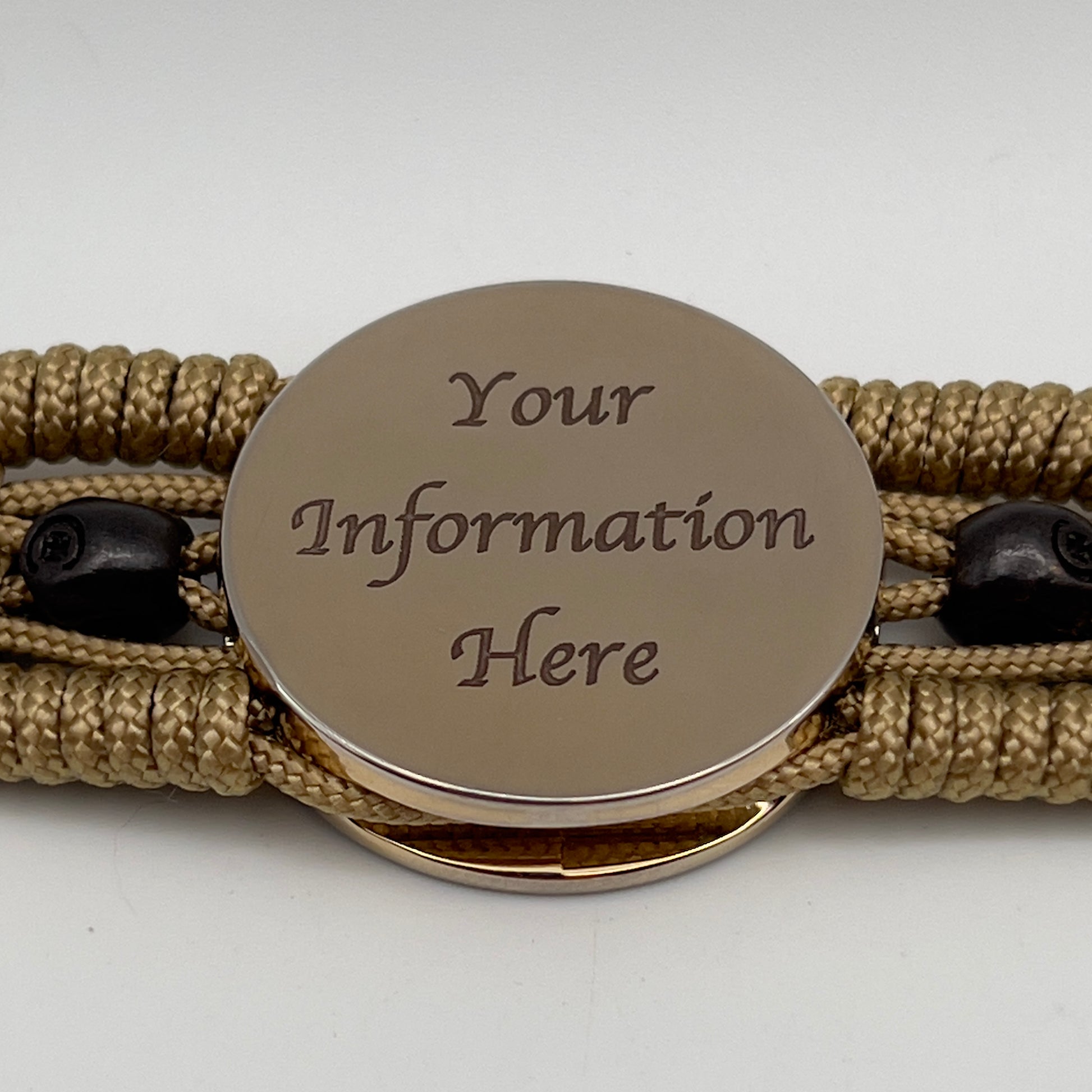 Thin, medium width, flexible and comfortable braided United States Marine Corps bracelet featuring a 24K gold plated USMC officer Eagle Globe and Anchor medallion, two black micro skulls, a gold Cobra style tactical buckle and woven with gold Type-1 paracord.