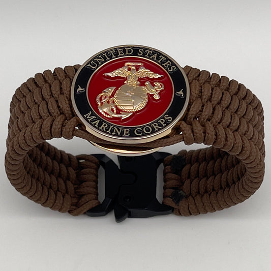 Thin, medium width, flexible and comfortable braided United States Marine Corps bracelet featuring a 24K gold plated USMC officer Eagle Globe and Anchor medallion, a gold Cobra style tactical buckle and woven with Coyote Brown Type-1 paracord.