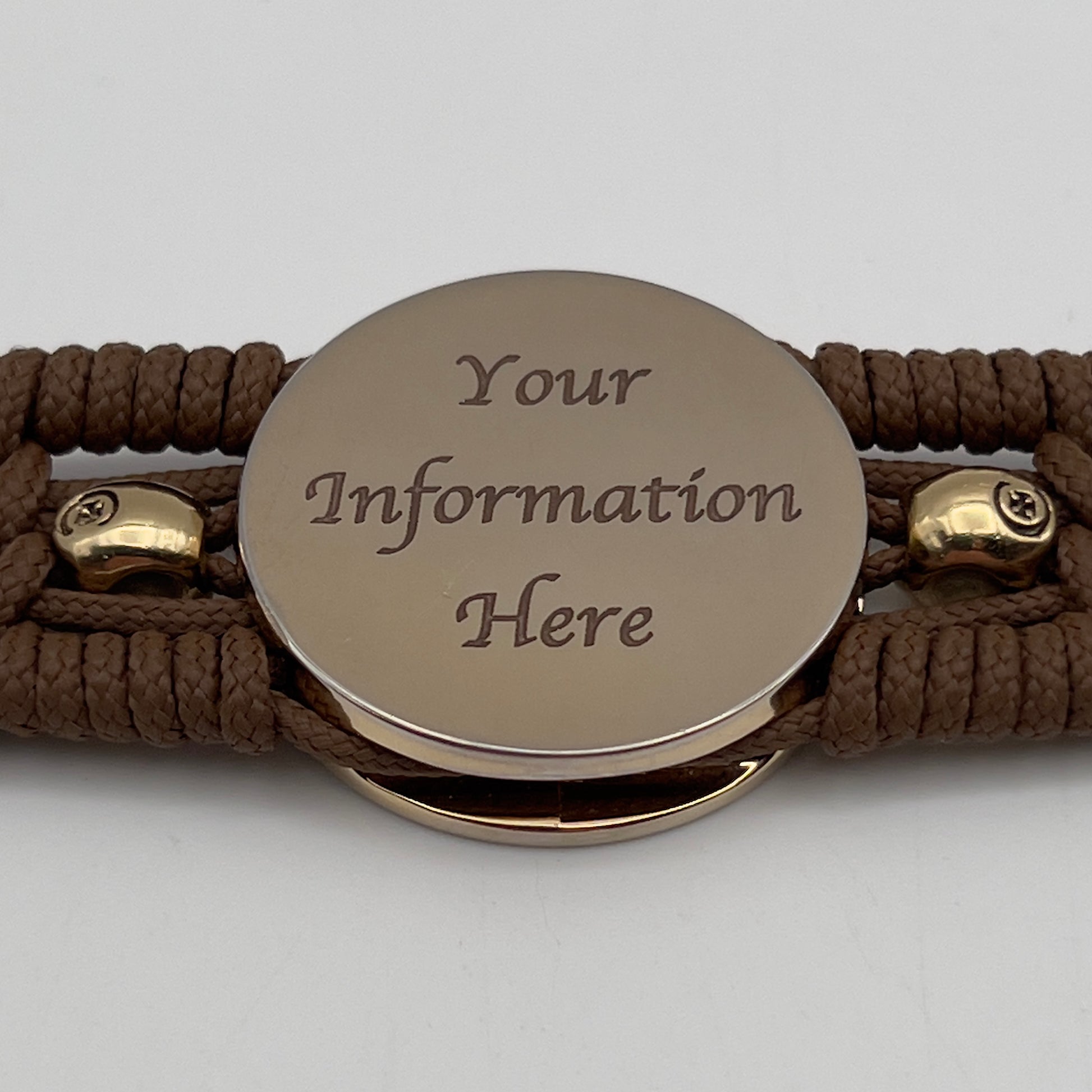 Thin, medium width, flexible and comfortable braided United States Marine Corps bracelet featuring a 24K gold plated USMC officer Eagle Globe and Anchor medallion, two gold plated skulls, a gold Cobra style tactical buckle and woven with Coyote Brown Type-1 paracord.
