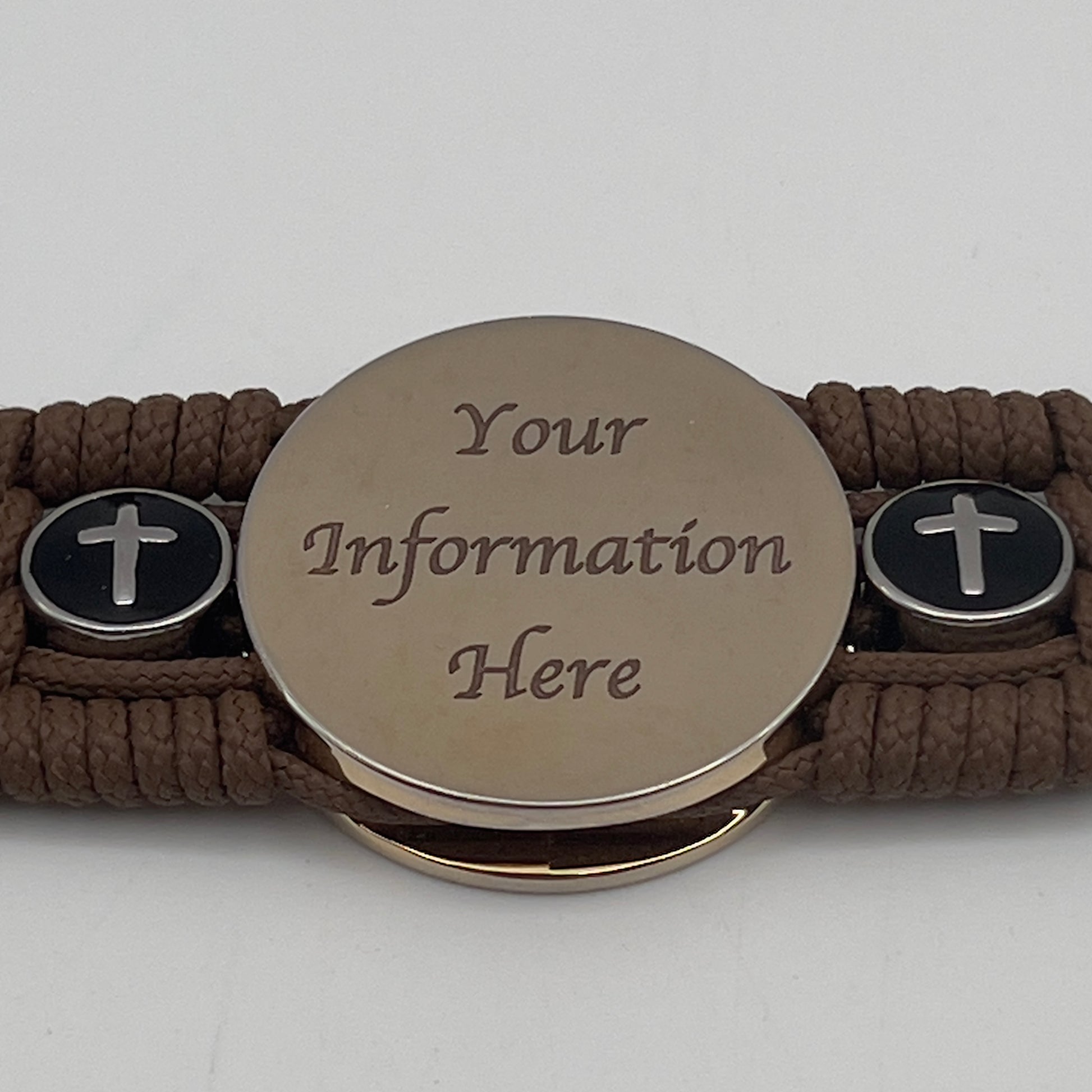 Thin, medium width, flexible and comfortable braided United States Marine Corps bracelet featuring a 24K gold plated USMC officer Eagle Globe and Anchor medallion, two Christian crosses, a black Cobra style tactical buckle and woven with Coyote Brown Type-1 paracord.