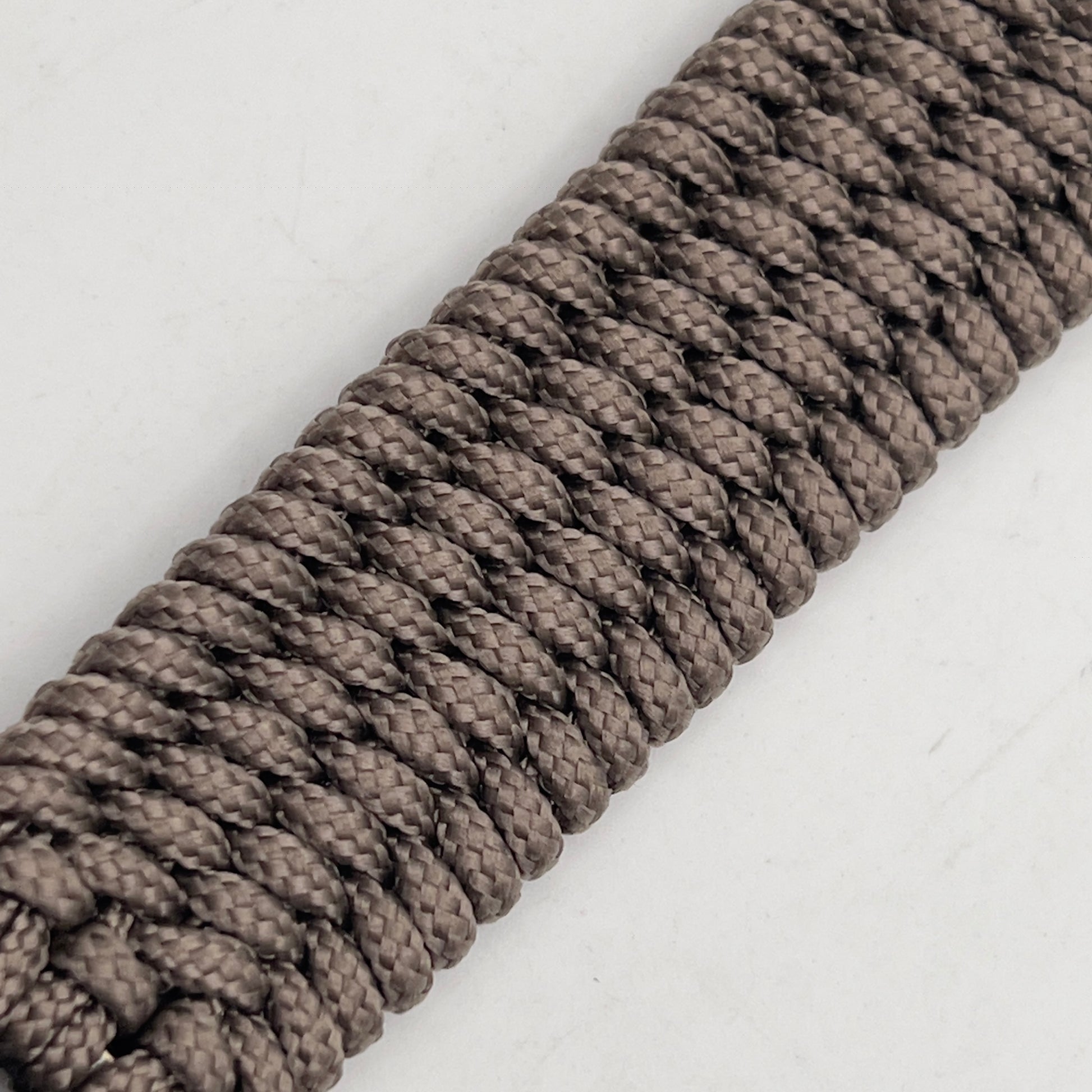 Thin, medium width, flexible and comfortable braided United States Marine Corps bracelet featuring a 24K gold plated USMC officer Eagle Globe and Anchor medallion, a gold Cobra style tactical buckle and woven with Tan Type-1 paracord.