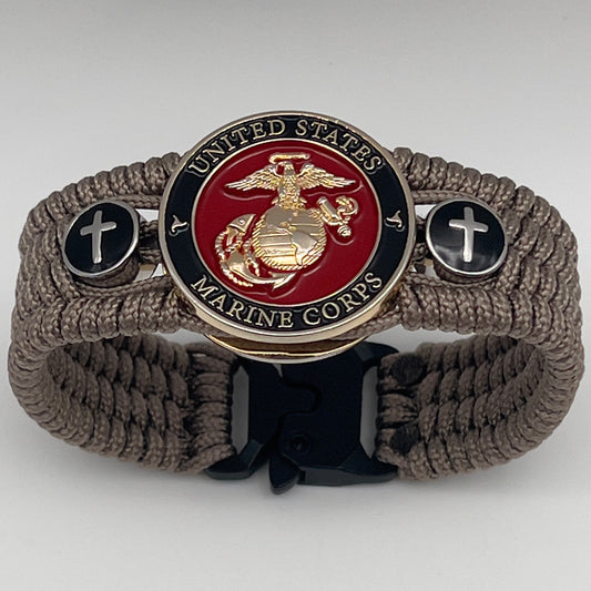 Thin, medium width, flexible and comfortable braided United States Marine Corps bracelet featuring a 24K gold plated USMC officer Eagle Globe and Anchor medallion, two Christian crosses, a black Cobra style tactical buckle and woven with Tan Type-1 paracord.