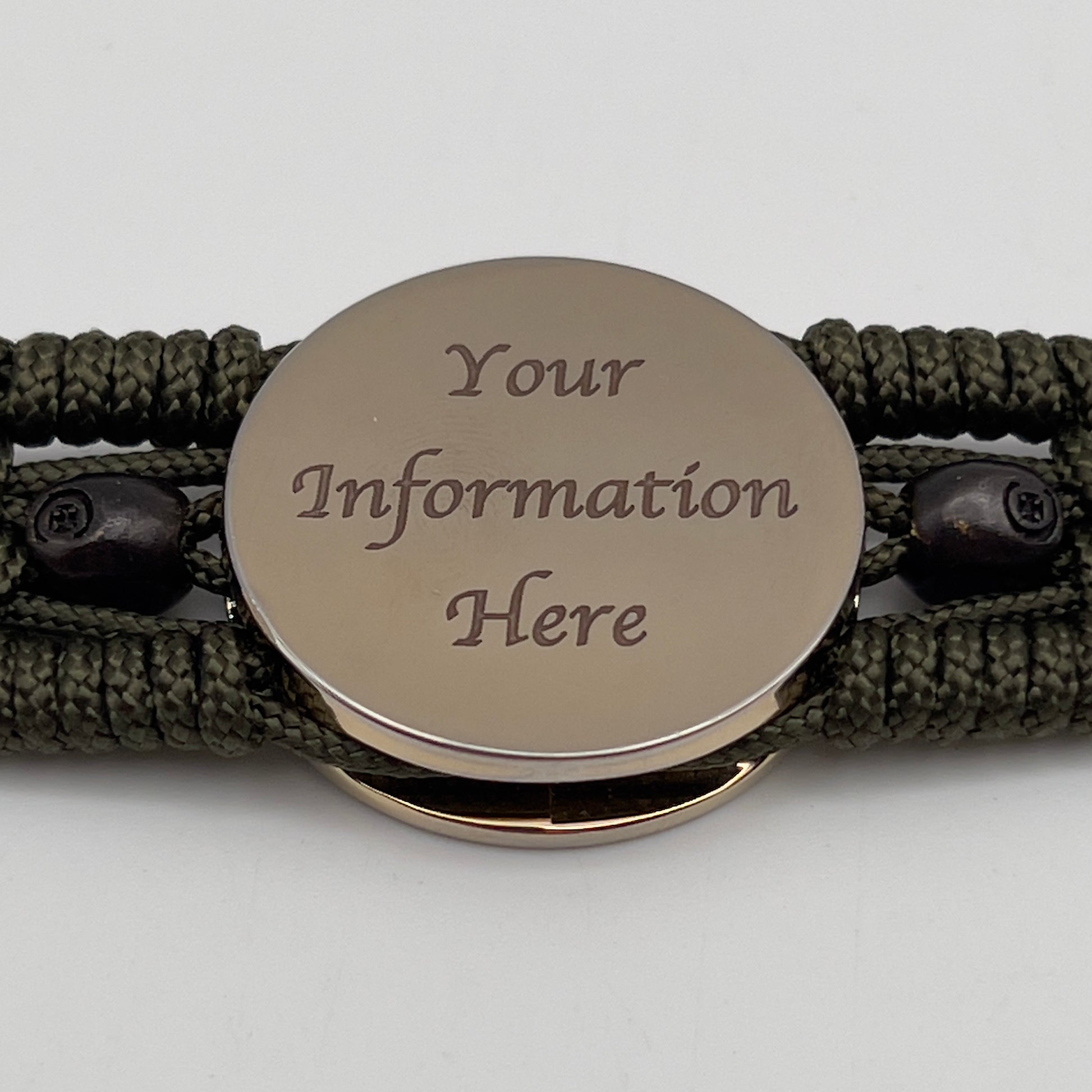 Thin, medium width, flexible and comfortable braided United States Marine Corps bracelet featuring a 24K gold plated USMC officer Eagle Globe and Anchor medallion, two black micro skulls, a black Cobra style tactical buckle and woven with Olive Drab Type-1 paracord.
