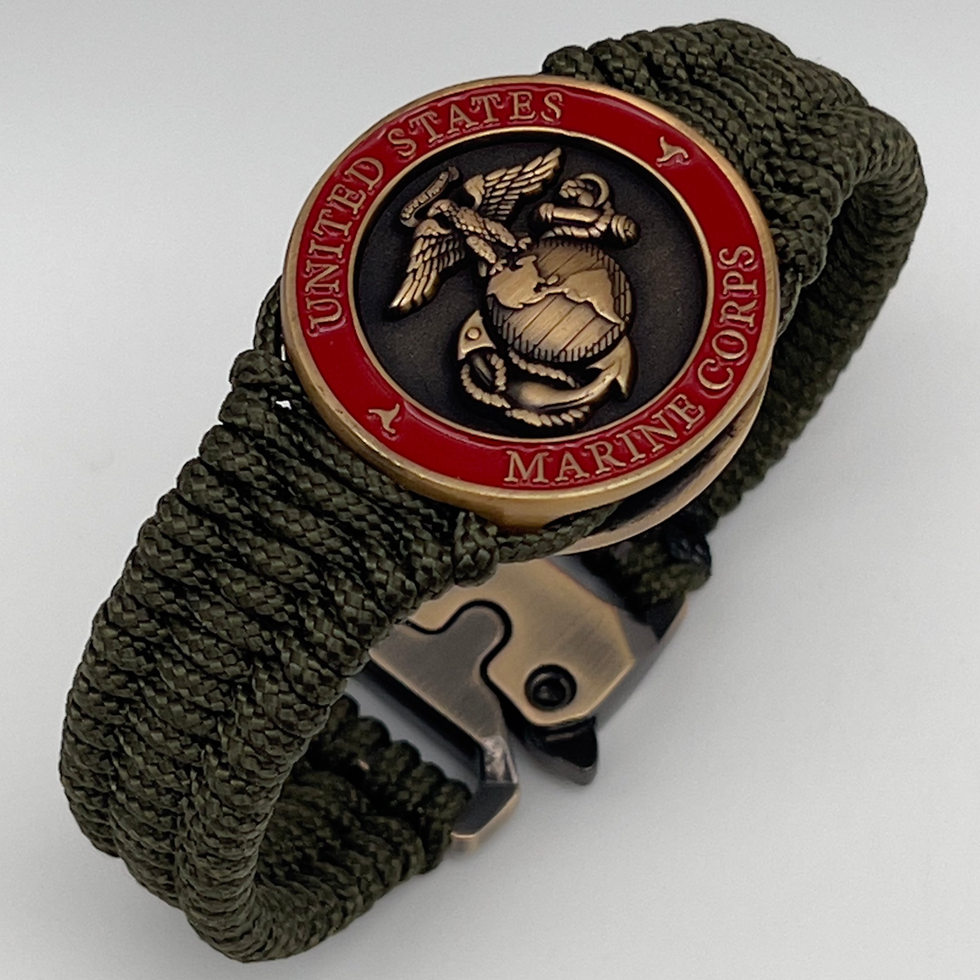 Thin, narrow, flexible and comfortable braided United States Marine Corps bracelet featuring a 24K antique gold plated USMC Eagle Globe and Anchor medallion, a gold Cobra style tactical buckle and woven with Olive Drab Type-1 paracord.