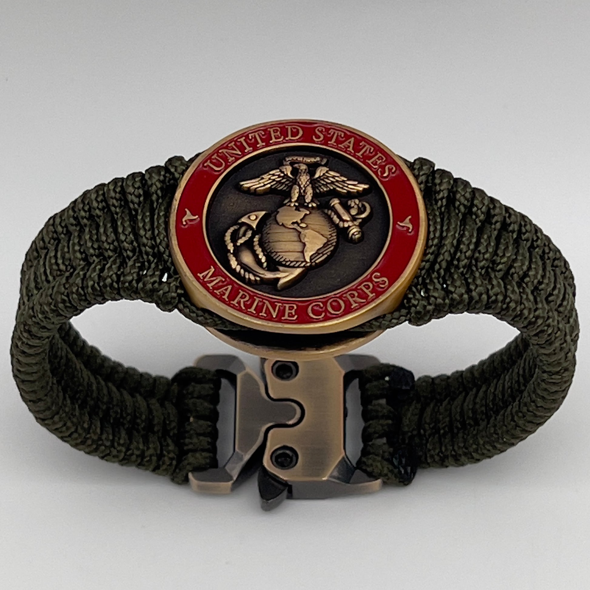 Thin, narrow, flexible and comfortable braided United States Marine Corps bracelet featuring a 24K antique gold plated USMC Eagle Globe and Anchor medallion, a gold Cobra style tactical buckle and woven with Olive Drab Type-1 paracord.