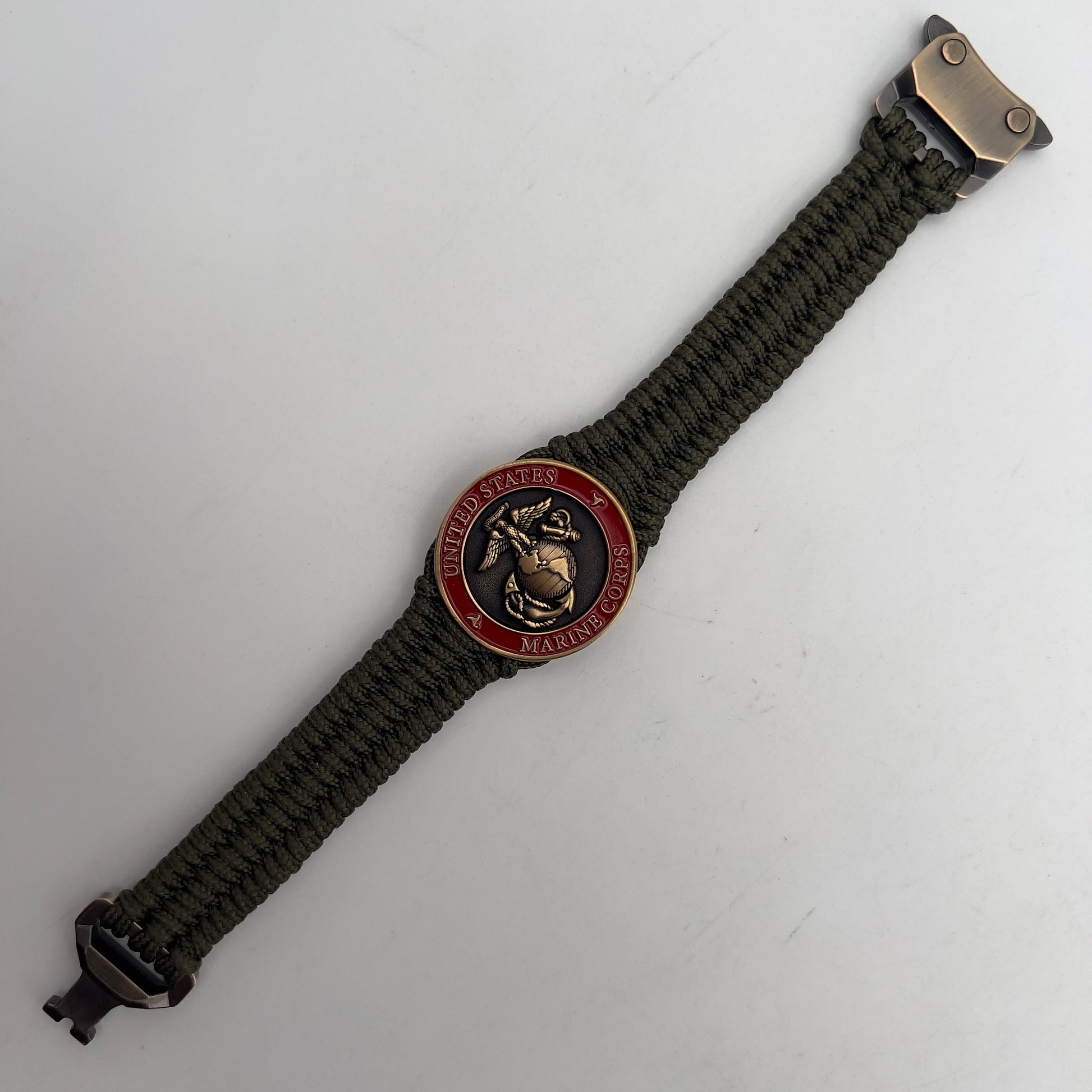Thin, narrow, flexible and comfortable braided United States Marine Corps bracelet featuring a 24K antique gold plated USMC Eagle Globe and Anchor medallion, a gold Cobra style tactical buckle and woven with Olive Drab Type-1 paracord.