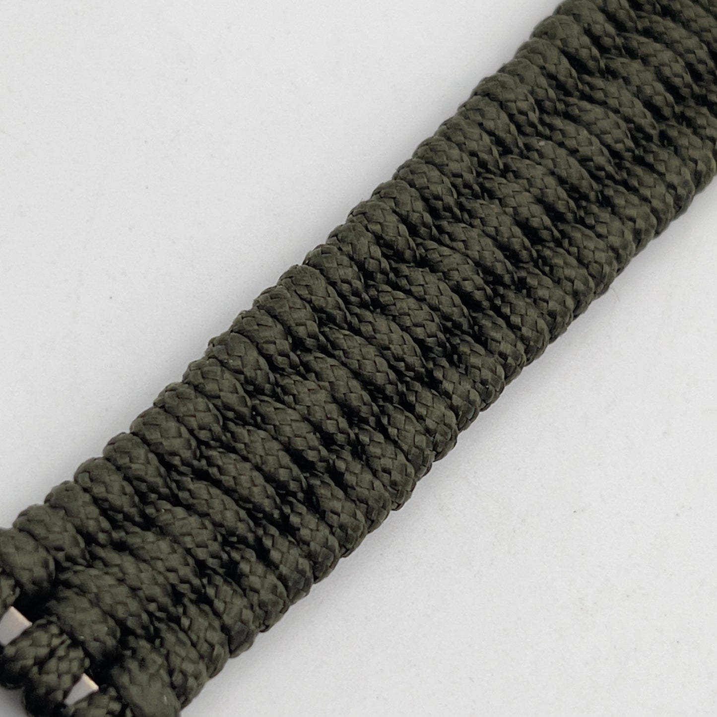 Thin, narrow, flexible and comfortable braided United States Marine Corps bracelet featuring a 24K antique gold plated USMC Eagle Globe and Anchor medallion, a gold Cobra style tactical buckle and woven with Olive Drab Type-1 paracord.