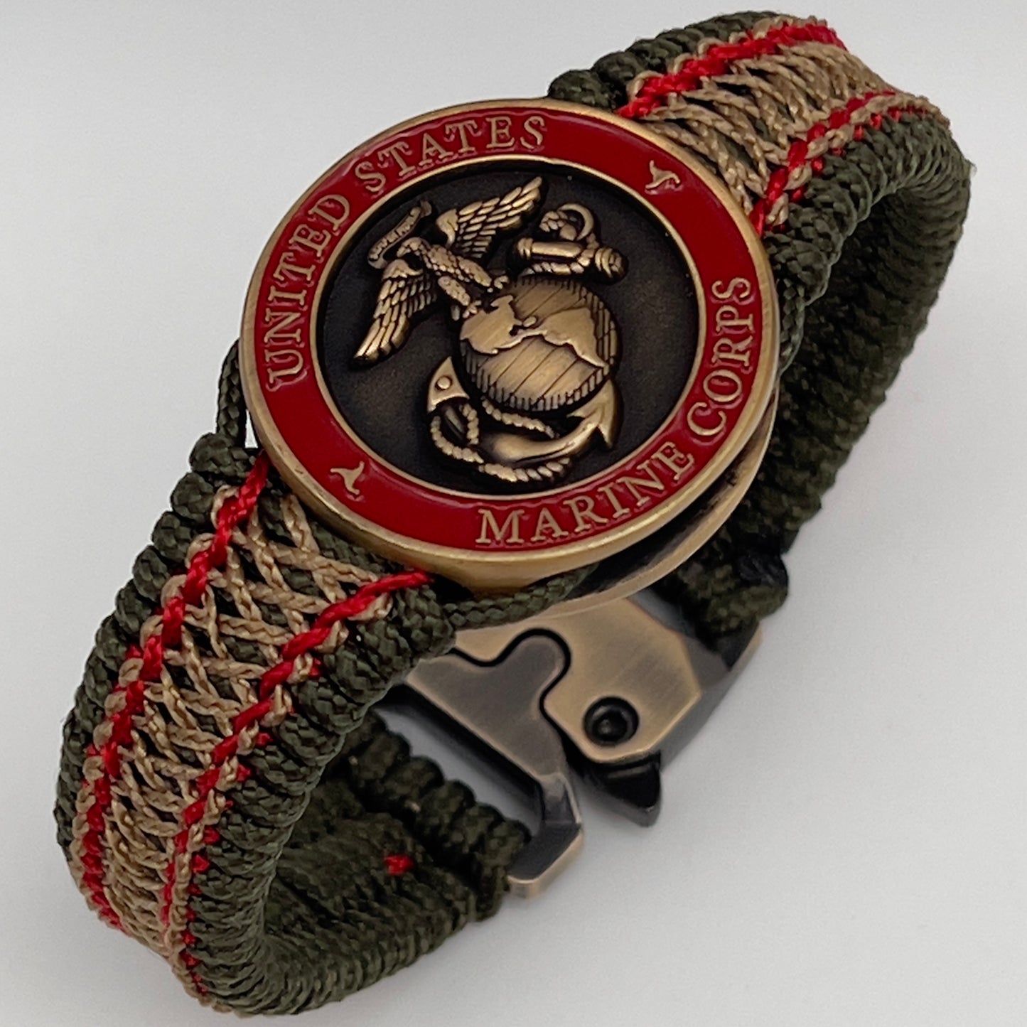 Thin, narrow, flexible and comfortable braided United States Marine Corps bracelet featuring a 24K antique gold plated USMC Eagle Globe and Anchor medallion, a gold Cobra style tactical buckle and woven with Olive Drab Type-1 paracord and Imperial Red and Gold nano cord.
