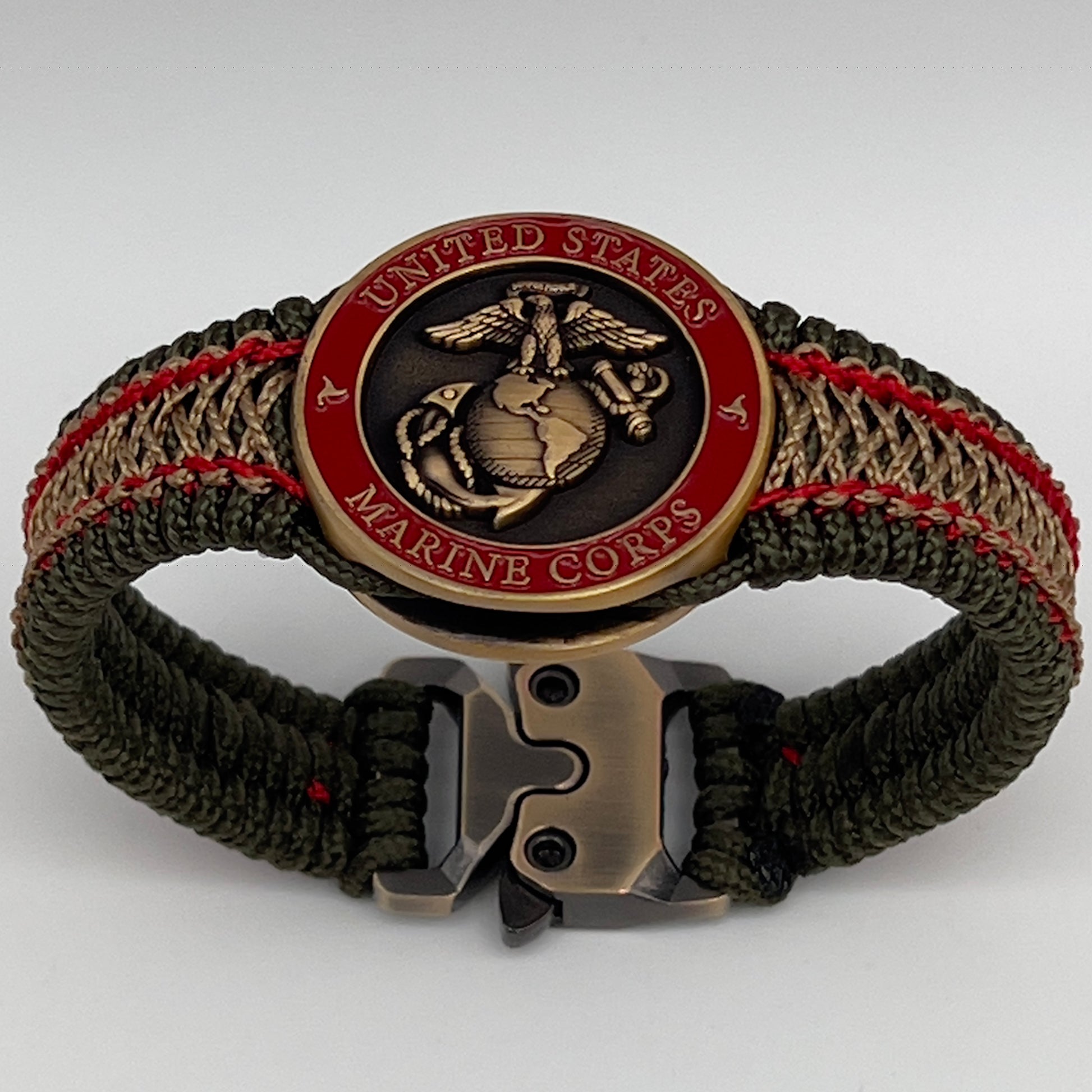 Thin, narrow, flexible and comfortable braided United States Marine Corps bracelet featuring a 24K antique gold plated USMC Eagle Globe and Anchor medallion, a gold Cobra style tactical buckle and woven with Olive Drab Type-1 paracord and Imperial Red and Gold nano cord.