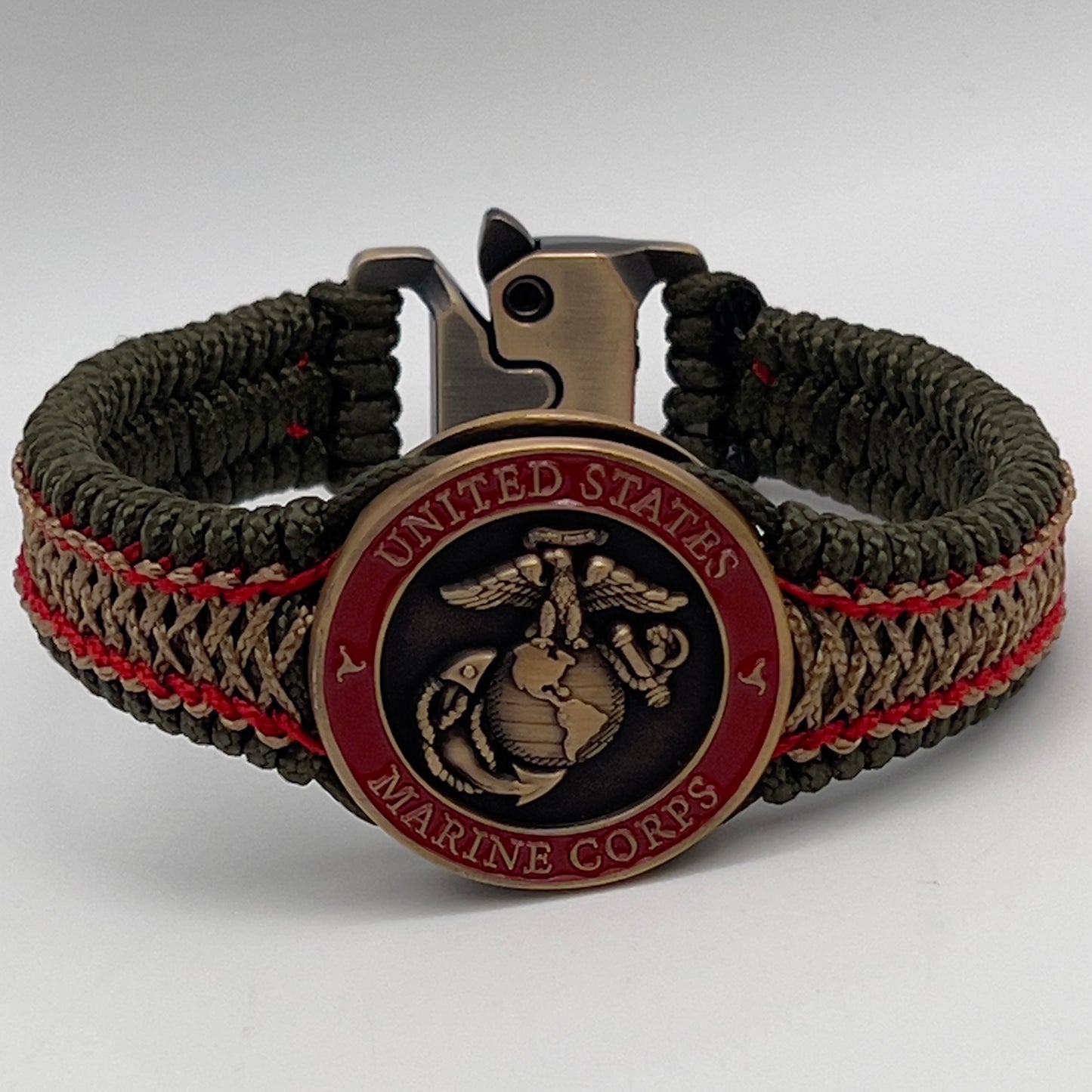 Thin, narrow, flexible and comfortable braided United States Marine Corps bracelet featuring a 24K antique gold plated USMC Eagle Globe and Anchor medallion, a gold Cobra style tactical buckle and woven with Olive Drab Type-1 paracord and Imperial Red and Gold nano cord.