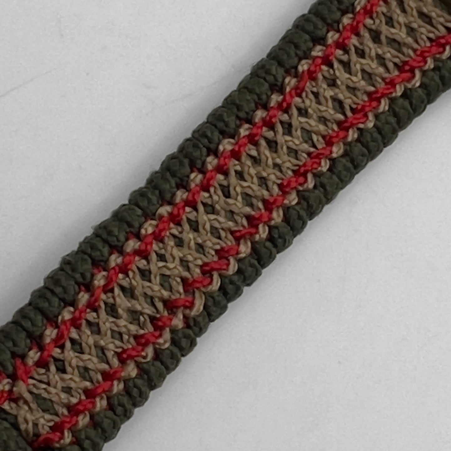Thin, narrow, flexible and comfortable braided United States Marine Corps bracelet featuring a 24K antique gold plated USMC Eagle Globe and Anchor medallion, a gold Cobra style tactical buckle and woven with Olive Drab Type-1 paracord and Imperial Red and Gold nano cord.