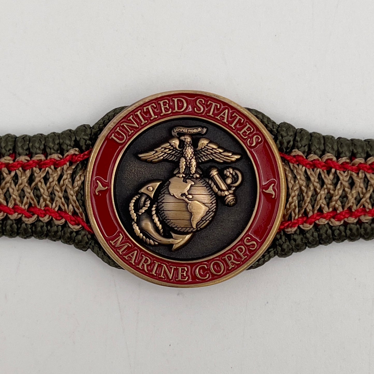Thin, narrow, flexible and comfortable braided United States Marine Corps bracelet featuring a 24K antique gold plated USMC Eagle Globe and Anchor medallion, a gold Cobra style tactical buckle and woven with Olive Drab Type-1 paracord and Imperial Red and Gold nano cord.