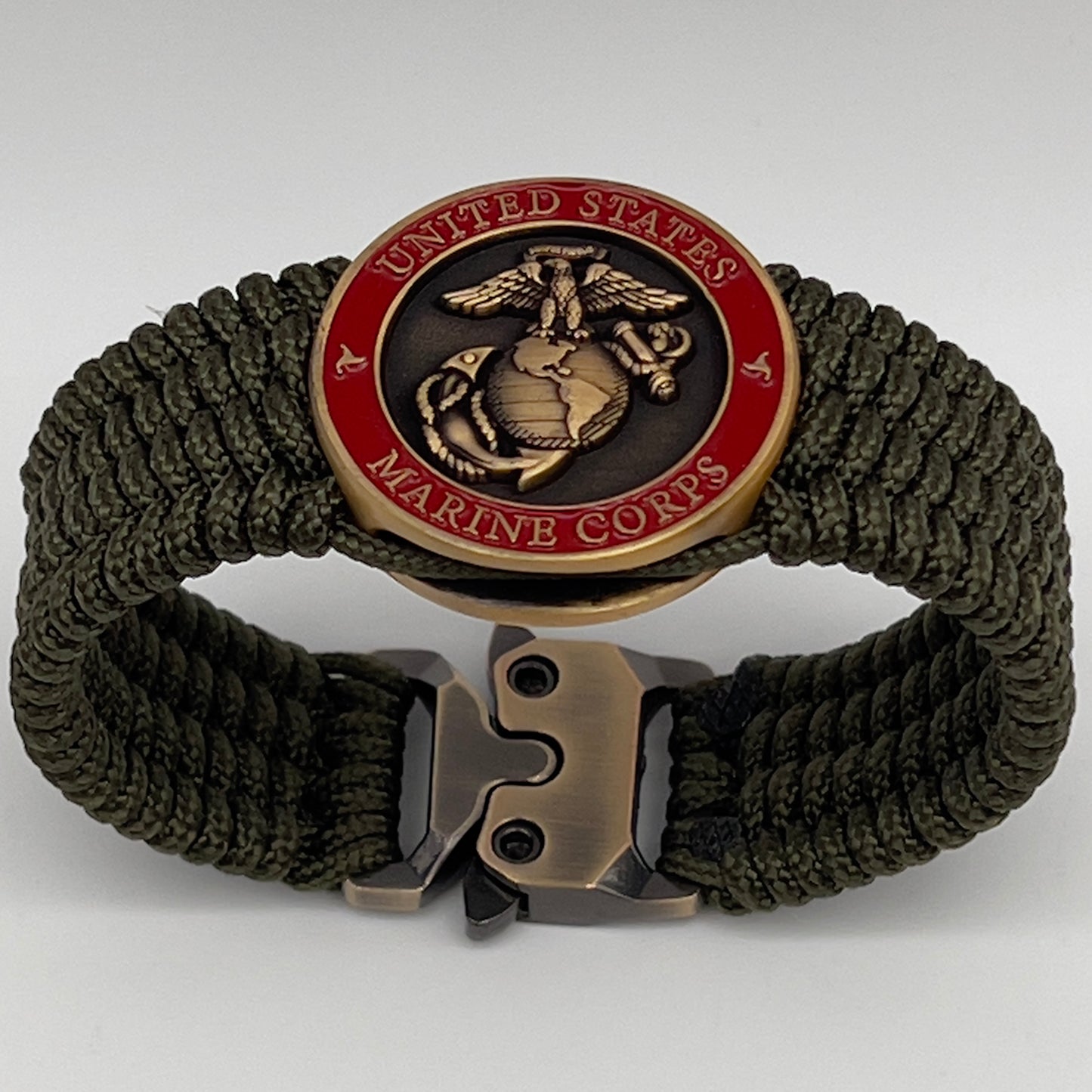 Thin, medium wide, flexible and comfortable braided United States Marine Corps bracelet featuring a 24K antique gold plated USMC Eagle Globe and Anchor medallion, a gold Cobra style tactical buckle and woven with Olive Drab Type-1 paracord.