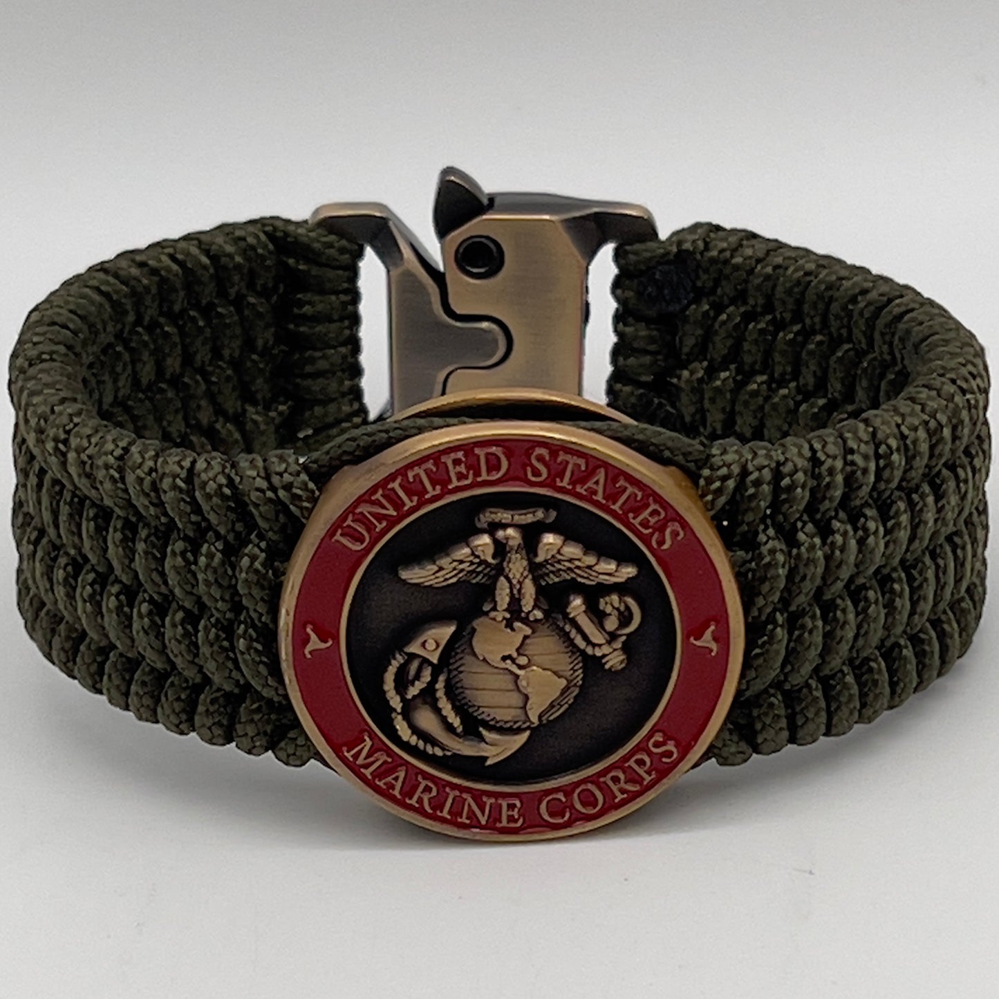 Thin, medium wide, flexible and comfortable braided United States Marine Corps bracelet featuring a 24K antique gold plated USMC Eagle Globe and Anchor medallion, a gold Cobra style tactical buckle and woven with Olive Drab Type-1 paracord.