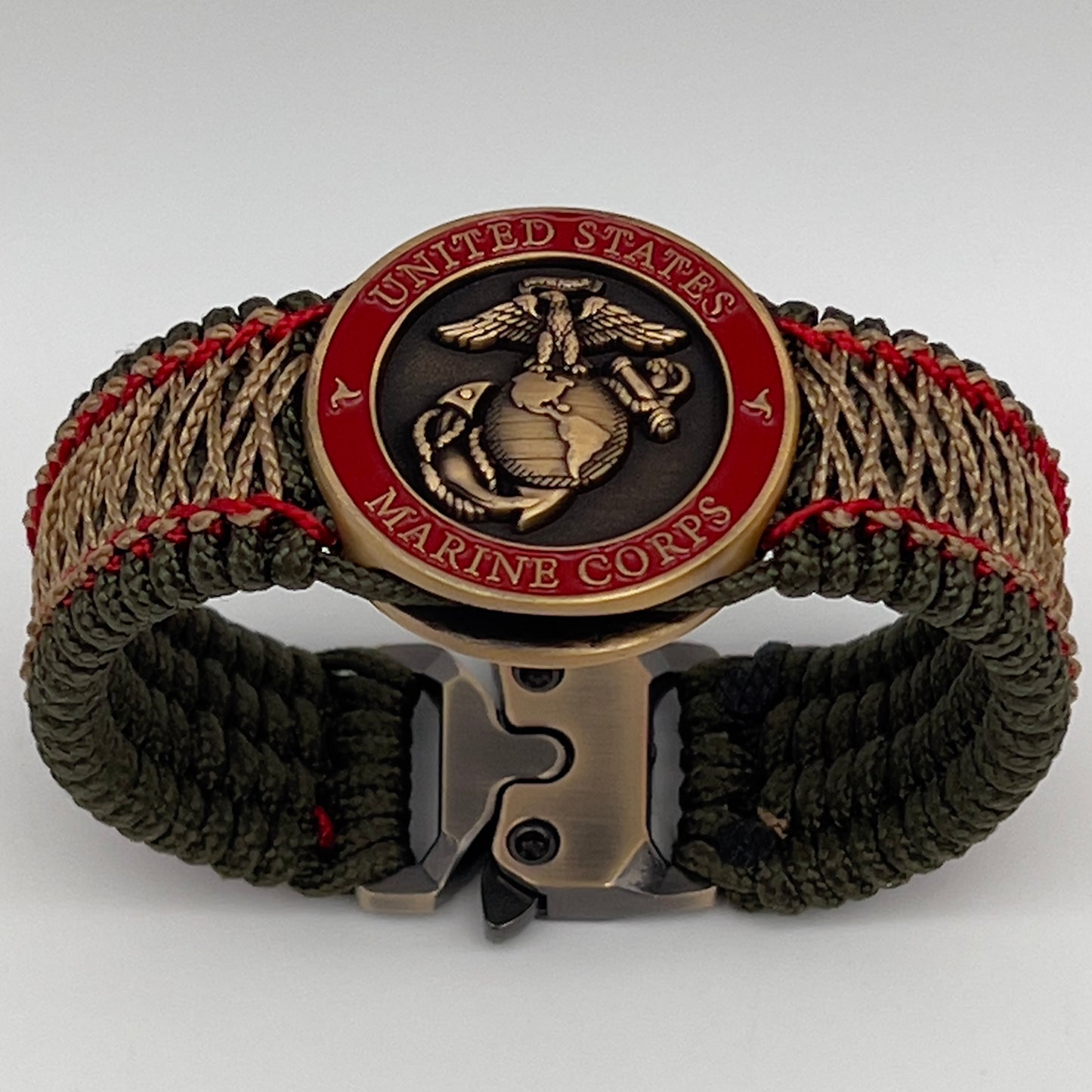 Thin, medium width, flexible and comfortable braided United States Marine Corps bracelet featuring a 24K antique gold plated USMC Eagle Globe and Anchor medallion, a gold Cobra style tactical buckle and woven with Olive Drab Type-1 paracord and Imperial Red and Gold nano cord.