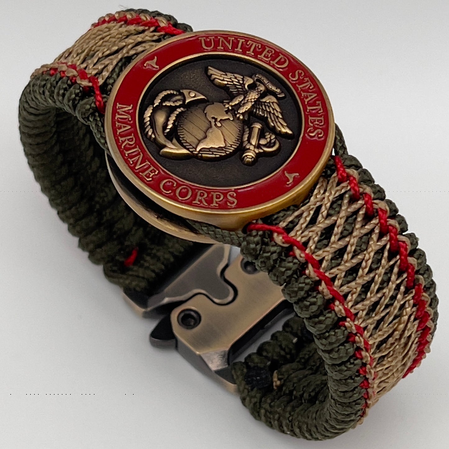 Thin, medium width, flexible and comfortable braided United States Marine Corps bracelet featuring a 24K antique gold plated USMC Eagle Globe and Anchor medallion, a gold Cobra style tactical buckle and woven with Olive Drab Type-1 paracord and Imperial Red and Gold nano cord.
