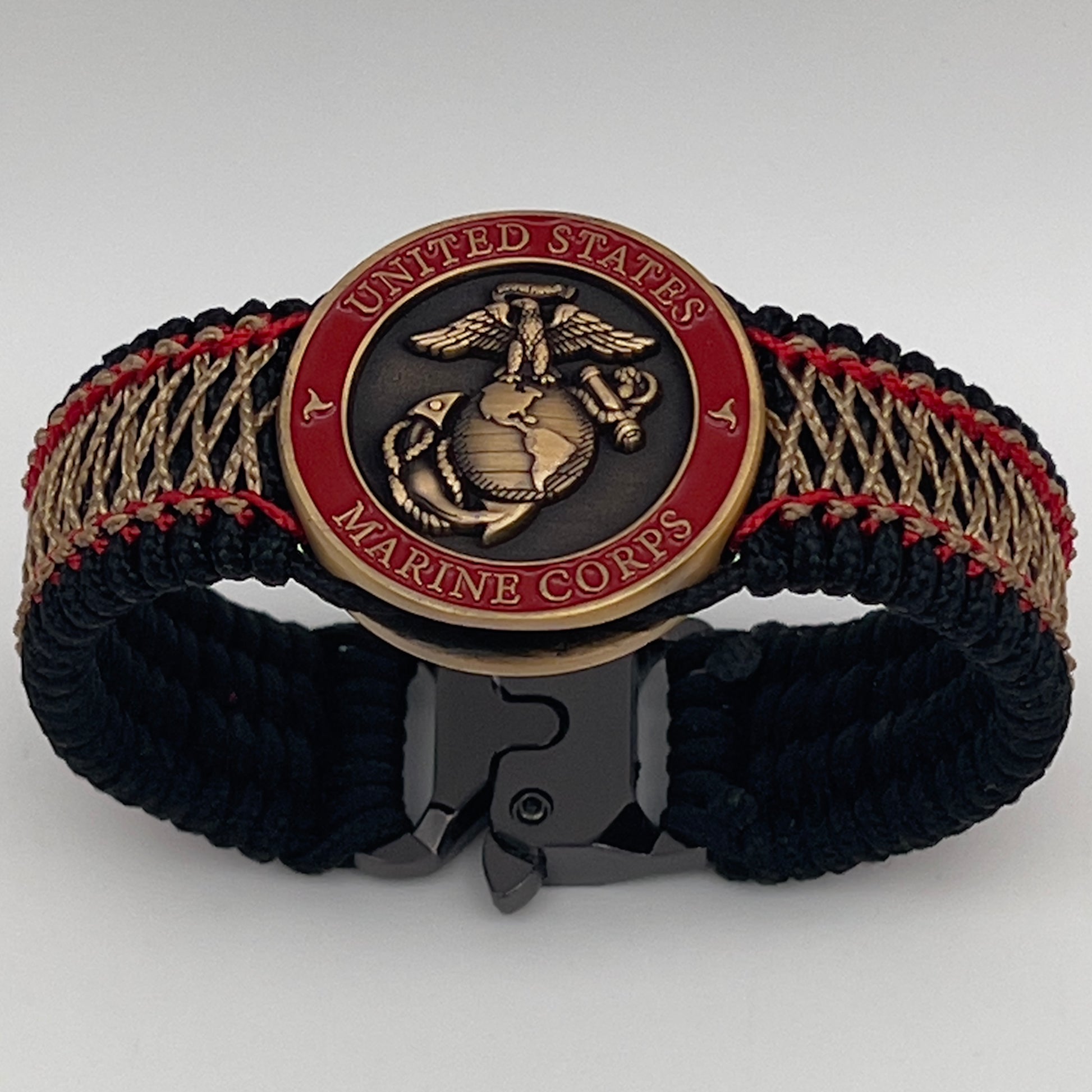 Thin, medium width, flexible and comfortable braided United States Marine Corps bracelet featuring a 24K antique gold plated USMC Eagle Globe and Anchor medallion, a black Cobra style tactical buckle and woven with black Type-1 paracord and Imperial Red and Gold nano cord.