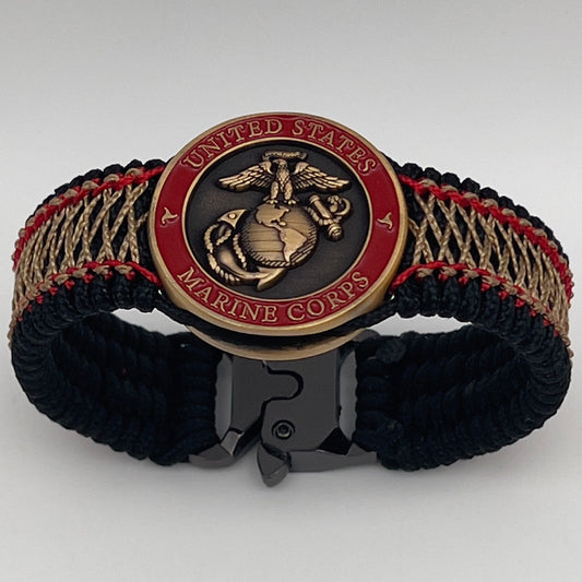 Thin, medium width, flexible and comfortable braided United States Marine Corps bracelet featuring a 24K antique gold plated USMC Eagle Globe and Anchor medallion, a black Cobra style tactical buckle and woven with black Type-1 paracord and Imperial Red and Gold nano cord.