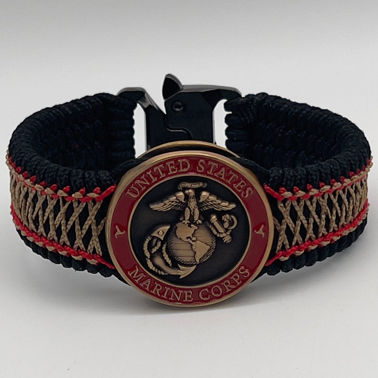 Thin, medium width, flexible and comfortable braided United States Marine Corps bracelet featuring a 24K antique gold plated USMC Eagle Globe and Anchor medallion, a black Cobra style tactical buckle and woven with black Type-1 paracord and Imperial Red and Gold nano cord.