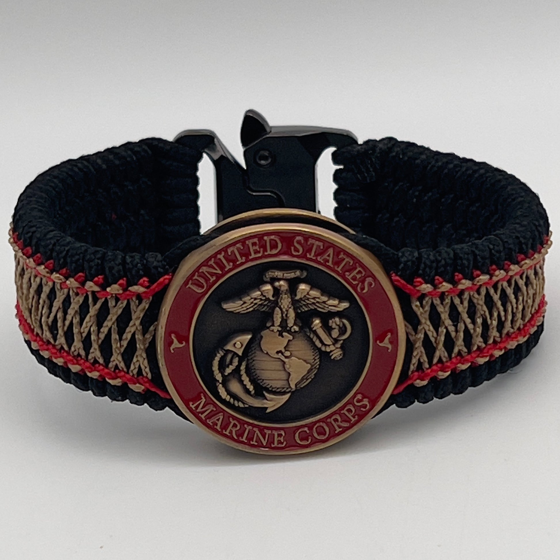 Thin, medium width, flexible and comfortable braided United States Marine Corps bracelet featuring a 24K antique gold plated USMC Eagle Globe and Anchor medallion, a black Cobra style tactical buckle and woven with black Type-1 paracord and Imperial Red and Gold nano cord.