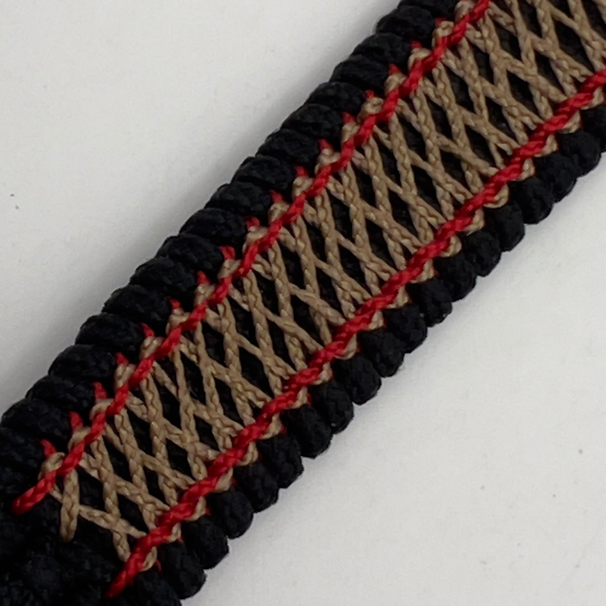 Thin, medium width, flexible and comfortable braided United States Marine Corps bracelet featuring a 24K antique gold plated USMC Eagle Globe and Anchor medallion, a black Cobra style tactical buckle and woven with black Type-1 paracord and Imperial Red and Gold nano cord.