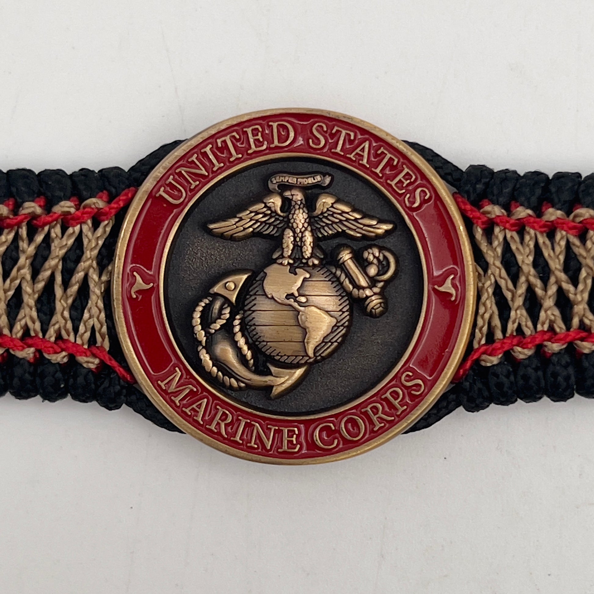 Thin, medium width, flexible and comfortable braided United States Marine Corps bracelet featuring a 24K antique gold plated USMC Eagle Globe and Anchor medallion, a black Cobra style tactical buckle and woven with black Type-1 paracord and Imperial Red and Gold nano cord.