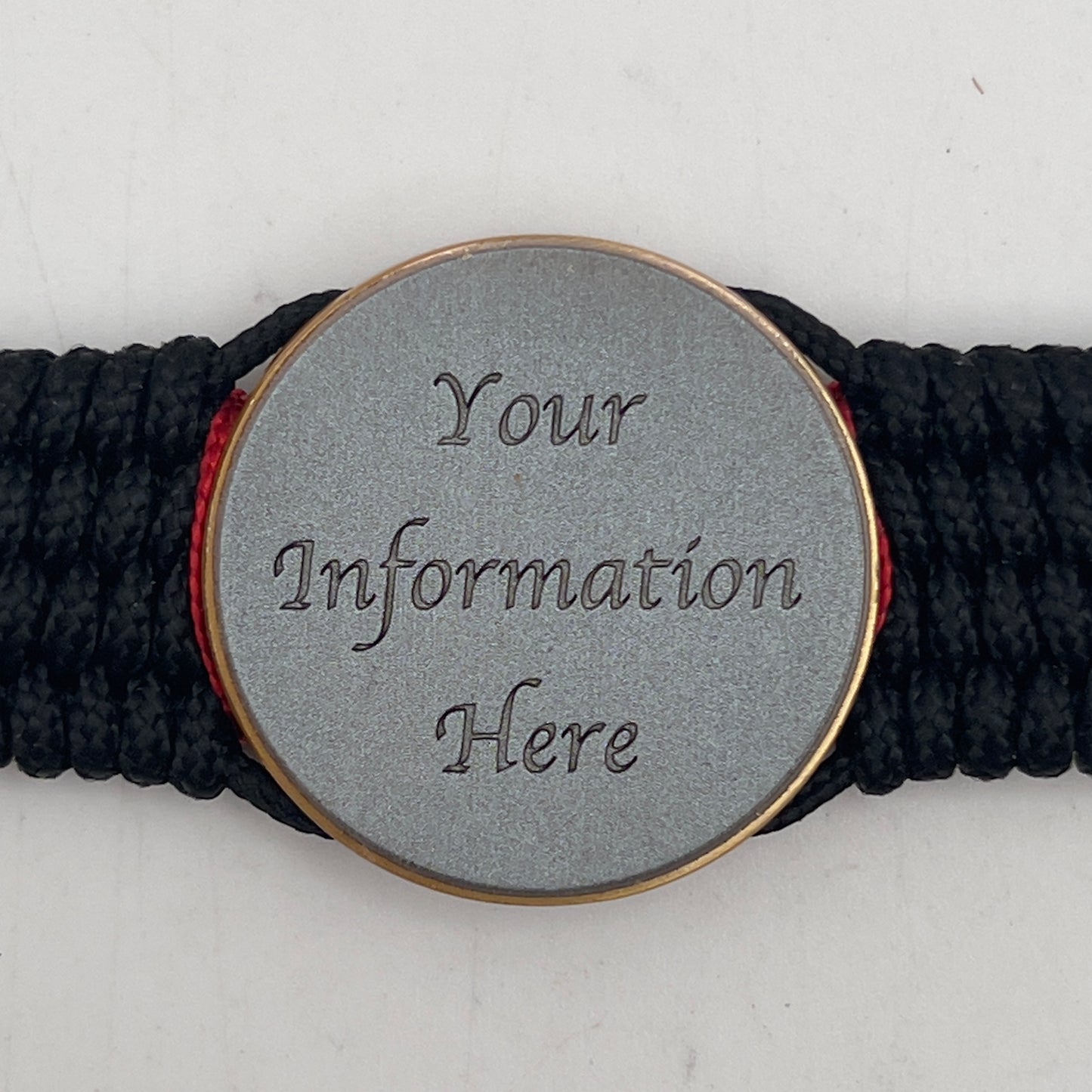 Thin, medium width, flexible and comfortable braided United States Marine Corps bracelet featuring a 24K antique gold plated USMC Eagle Globe and Anchor medallion, a black Cobra style tactical buckle and woven with black Type-1 paracord and Imperial Red and Gold nano cord.